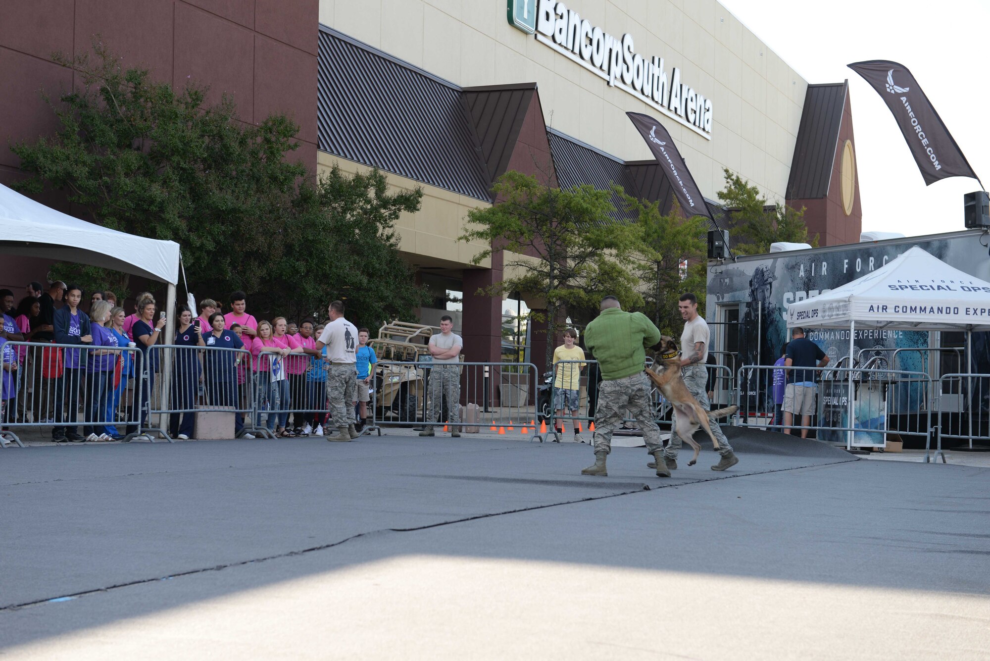 Senior Airman Logan Marini, 14th Security Forces Squadron Military Working Dog handler, gets bit while Staff Sgt. Zachary Kunkler, 14th Security Forces Squadron MWD handler, yells out commands during a MWD demonstration Oct. 2, 2018, during the Imagine the Possibilities Career Expo at the BancorpSouth Arena in Tupelo, Mississippi. Law enforcement was one of the seven pathways that Airmen from Columbus Air Force Base, Mississippi, represented. (U.S. Air Force photo by Airman Hannah Bean)