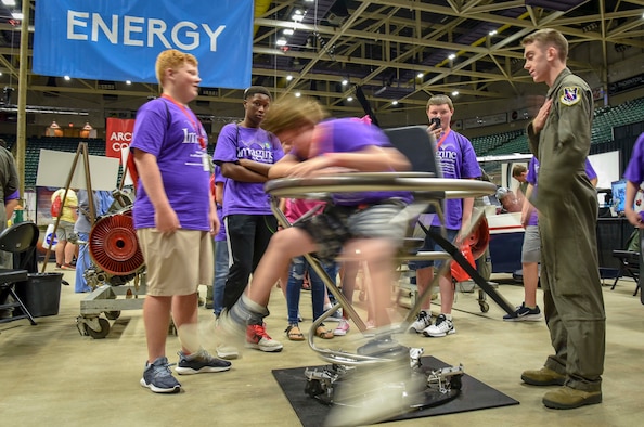 Airman 1st Class Anthony Halas, 14th Medical Operations Squadron, spins a student in a Barany Chair Oct. 2, 2018, during the Imagine the Possibilities Career Expo at the BancorpSouth Arena in Tupelo, Mississippi. More than 120 Airmen from Columbus AFB, Mississippi, spent several days showing more than 7,000 eighth-grade students, from northeast Mississippi counties, some of the vast career opportunities the Air Force offers. (U.S. Air Force photo by Tech. Sgt. Christopher Gross)
