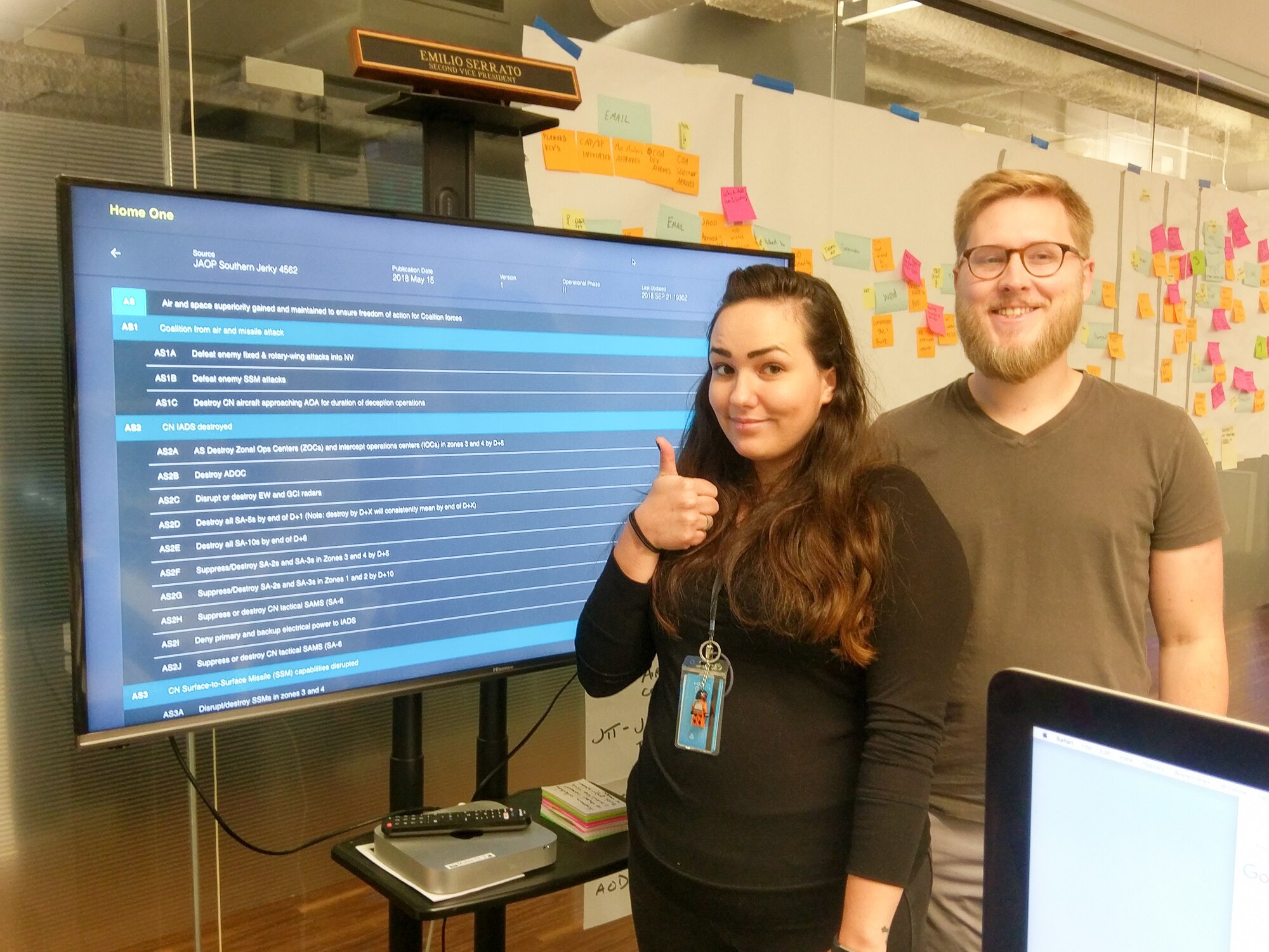 Staff Sgt. Kassandra Johnson, 2nd Systems Operations Squadron NCO in charge, Data Routing Team, and Mark Ducommun, an engineer, pose for a photo with their app, Home One, at the Pivotal Labs office in Chicago, Illinois, October 5, 2018. Cyber Airmen from the 557th Weather Wing have been working with innovative companies to develop software that can increase efficiency for the Air Force. (Courtesy Photo)