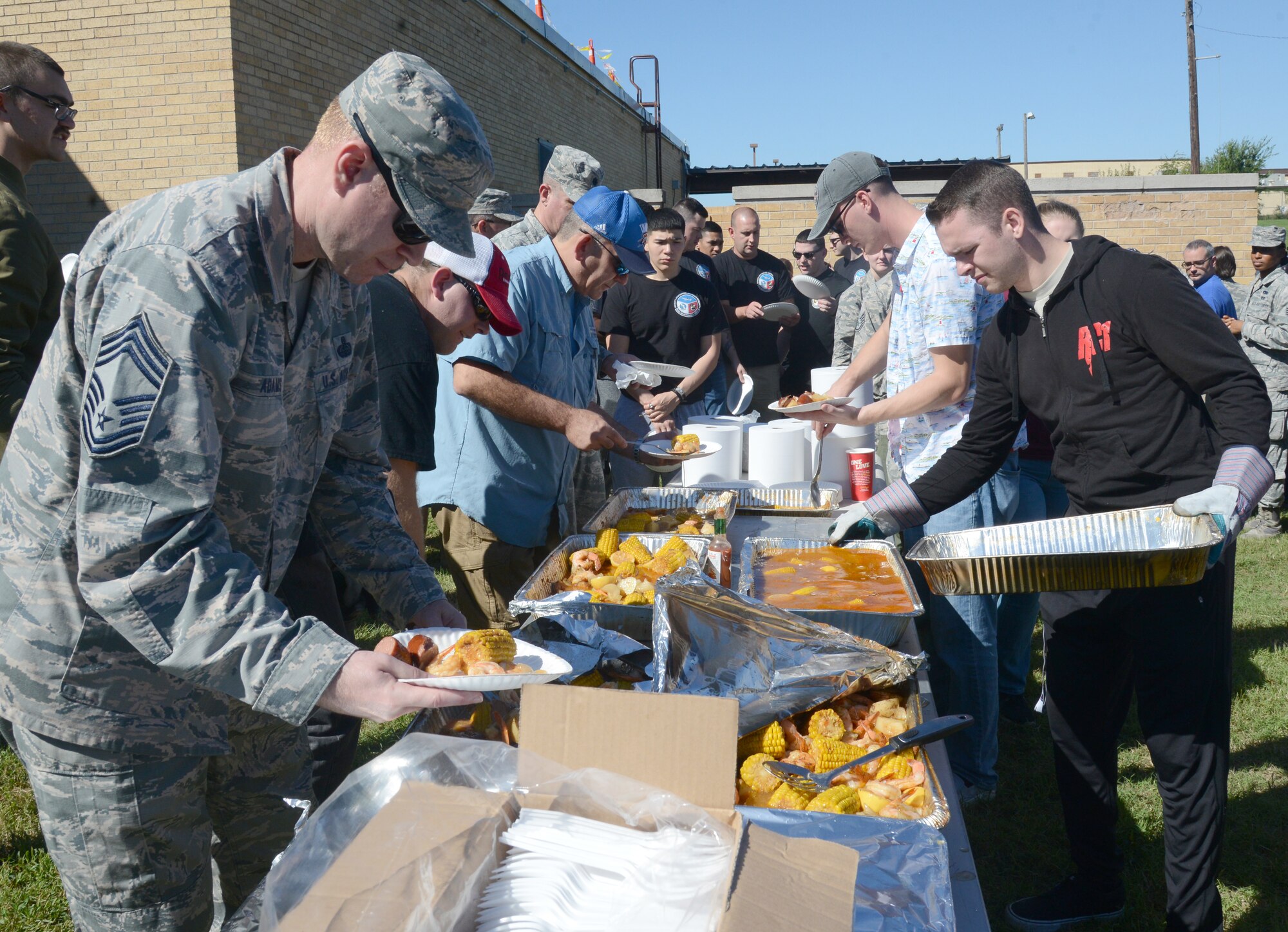 Members of the 552nd Air Control Wing lined up to fill their plates with shrimp, corn, potatoes and sausage during the Wing’s Freedom Fest Sept. 27.