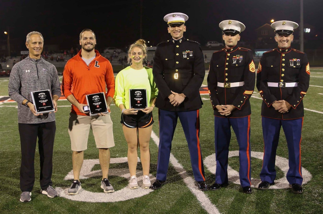 Marines with Recruiting Station Indianapolis presented an award to Logansport High School senior Mia Loposser on Oct. 5, in Indianapolis for being one of 96 in the nation and two in the state of Indiana to be selected to attend the Marine Corps Battles Won Academy. Loposser attended the Marine Corps event in July. (U.S. Marine Corps photo by Sgt. Carl King )