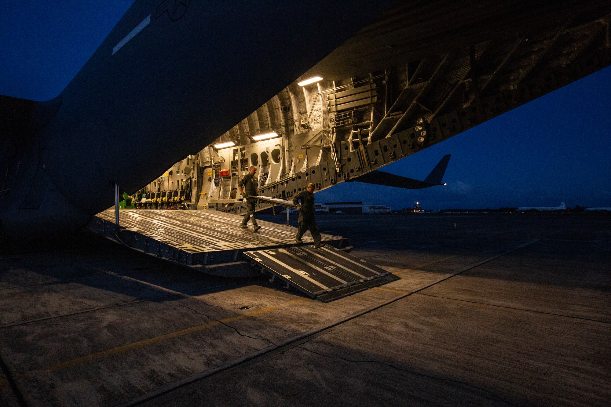 U.S. Air Force Senior Airman Erica C. Funke, right, an aeromedical evacuation technician with the 514th Aeromedical Evacuation Squadron (AES), 514th Air Mobility Wing, and 1st Lt. Bogdan N. Suciu, a flight nurse with the 439th AES, unload a stretcher prior to the return trip to Joint Base McGuire-Dix-Lakehurst, N.J., Oct. 7, 2018 after a joint training mission with the 514th AES, 45th AES, and the 439th AES at Barbers Point, Hawaii. The 514th is an Air Force Reserve Command unit at Joint Base McGuire-Dix-Lakehurst. The 45th and the 439th AES are Air Force Reserve Command units from MacDill Air Force Base, Fla., and Westover Air Reserve Base, Mass. (U.S. Air Force photo by Master Sgt. Mark C. Olsen)