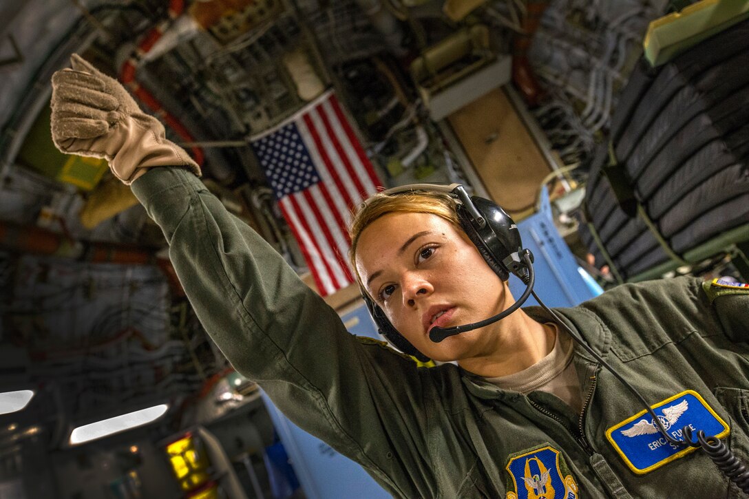 U.S. Air Force Senior Airman Erica C. Funke, an aeromedical evacuation technician with the 514th Aeromedical Evacuation Squadron (AES), 514th Air Mobility Wing, signals aeromedical evacuation technicians to bring a patient litter on board a C-17 Globemaster III prior to the return trip to Joint Base McGuire-Dix-Lakehurst, N.J., Oct. 7, 2018 after a joint training mission with the 514th AES, 45th AES, and the 439th AES at Barbers Point, Hawaii. The 514th is an Air Force Reserve Command unit at Joint Base McGuire-Dix-Lakehurst. The 45th and the 439th AES are Air Force Reserve Command units from MacDill Air Force Base, Fla., and Westover Air Reserve Base, Mass. (U.S. Air Force photo by Master Sgt. Mark C. Olsen)