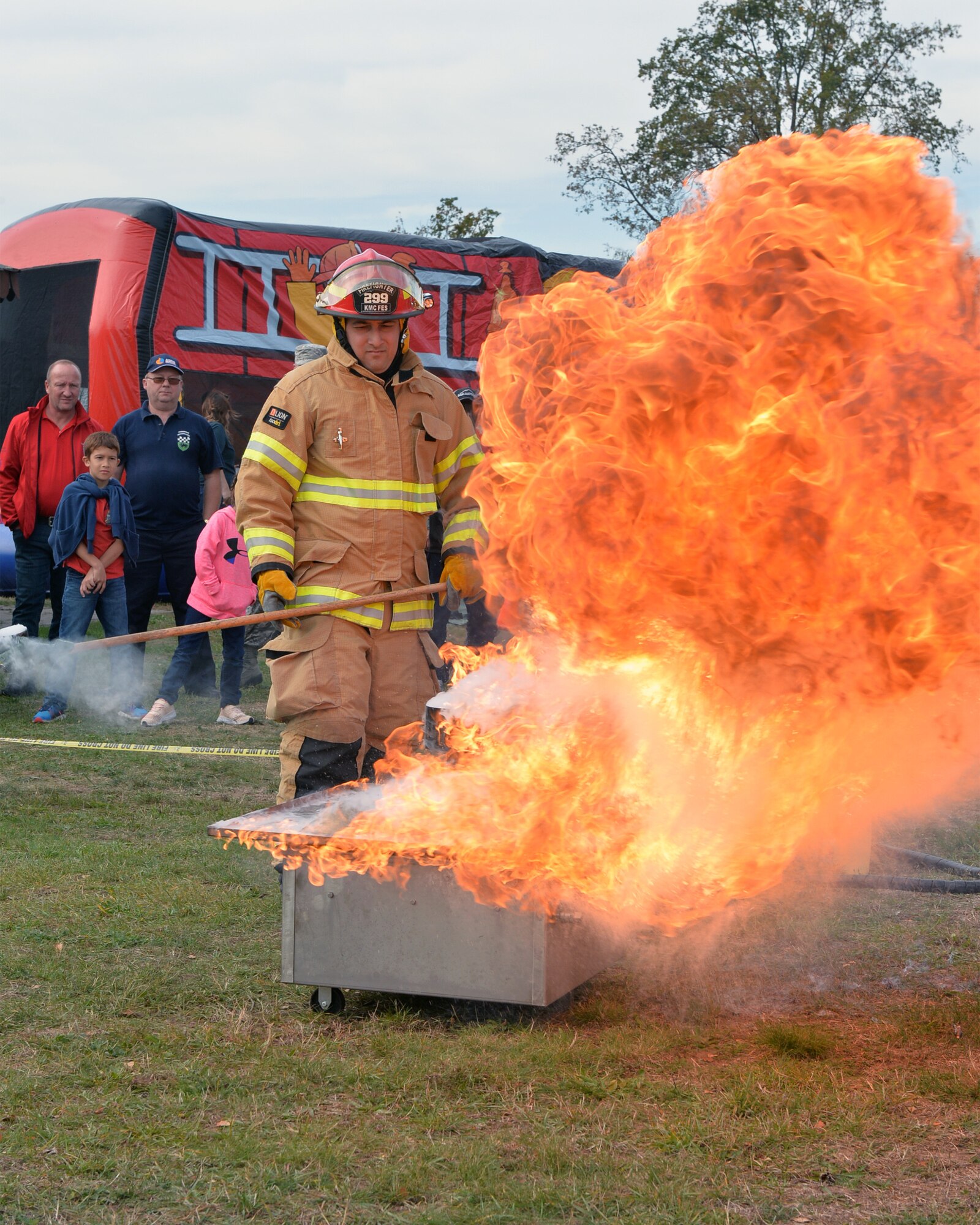 A firefighter with the Kaiserslautern Military Community Fire and Emergency Services demonstrates what happens when water is poured on a grease fire on Ramstein Air Base, Germany, Oct. 6, 2018. If a grease fire happens, the fire should be smothered by placing the lid on the pot or pan to prevent oxygen from feeding the flames. After a lid has been placed on the pot or pan, the fire department should be called. (U.S. Air Force photo by Staff Sgt. Jimmie D. Pike)