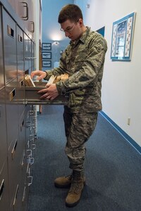 A 12th Training Squadron detail Airman, sorts through the Order of Daedalion’s flight records April 18, 2018 at the Daedalian Foundation National Headquarters building on Joint Base San Antonio-Randolph, Texas. The Order of Daedalians has a record of every military flight conducted by its members organized and on file for those interested to look through. (U.S. Air Force photo by Airman Shelby Pruitt)