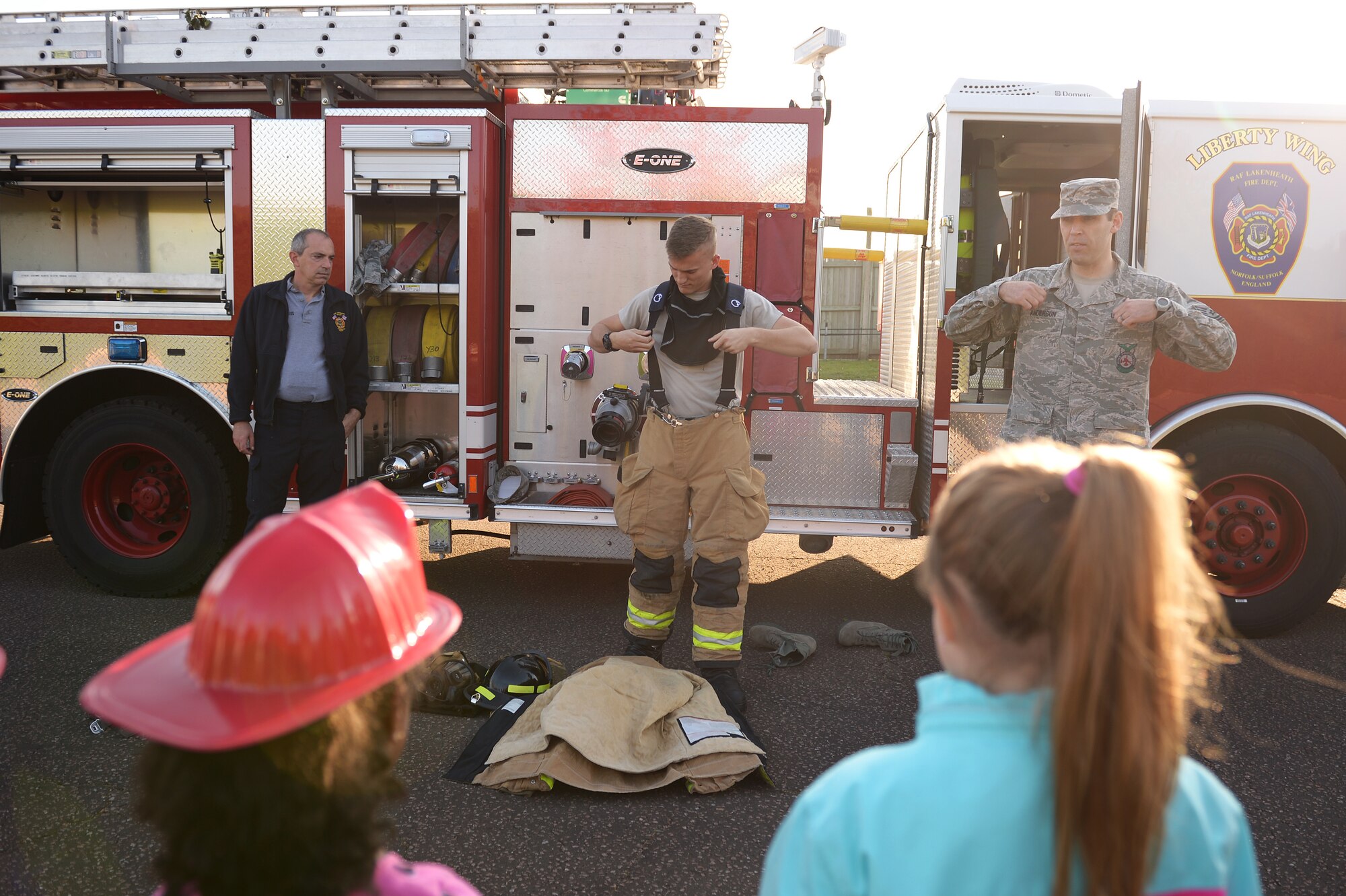 A 48th Civil Engineer Squadron firefighter demonstrates how he prepares to fight fires during Fire Prevention Week at Royal Air Force Lakenheath, England, Oct.10, 2018. This year’s FPW campaign focuses on educating communities about three essential steps to reduce the likelihood of having a fire and how to escape a fire safely. (U.S.Air Force photo/Airman 1st Class Shanice Williams-Jones)