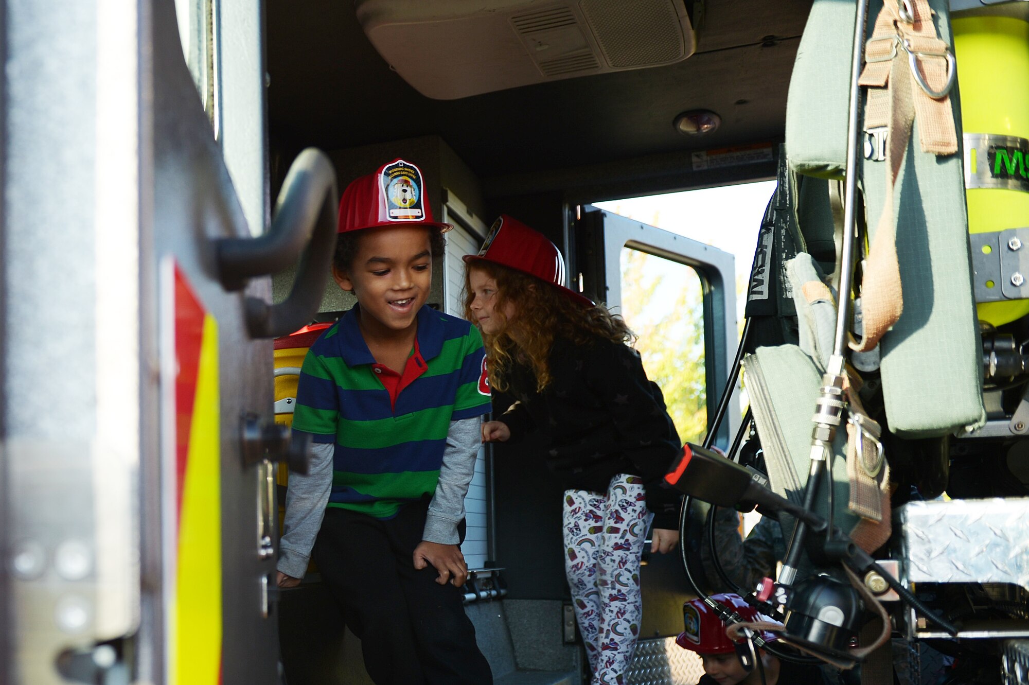 Lakenheath Elementary School children explore a fire truck during Fire Prevention Week at Royal Air Force Lakenheath, England, Oct. 10, 2018. The children had the chance to practice fire drills and witness fire saftey demonstrations in observance of FPW. (U.S. Air Force photo/Airman 1st Class Shanice Williams-Jones)