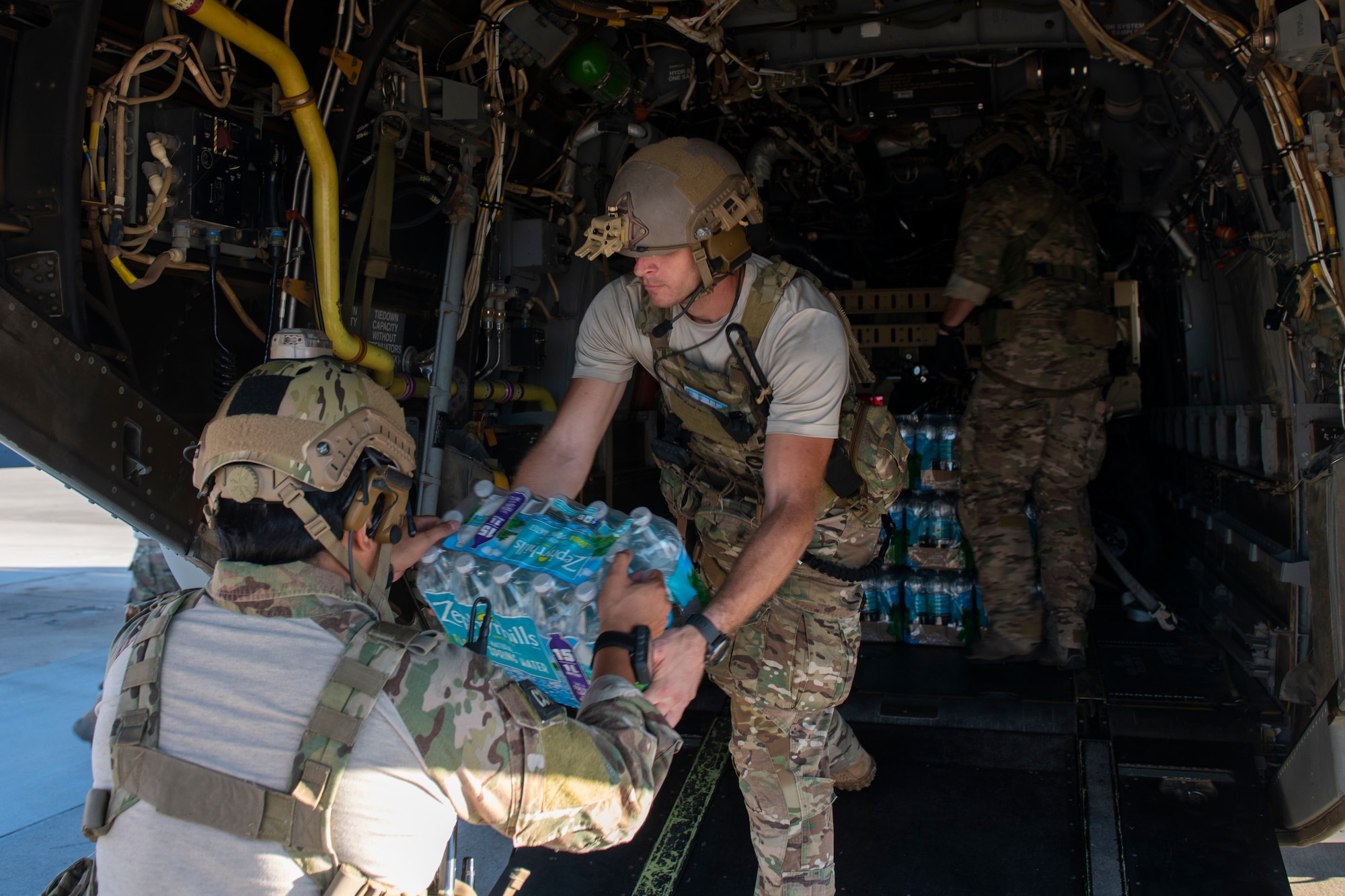 U.S. Air Force Special Tactics Airmen with the 23rd Special Tactics Squadron load water onto a CV-22 Osprey tiltrotor aircraft assigned to the 8th Special Operations Squadron at Hurlburt Field, Florida, Oct. 11, 2018.