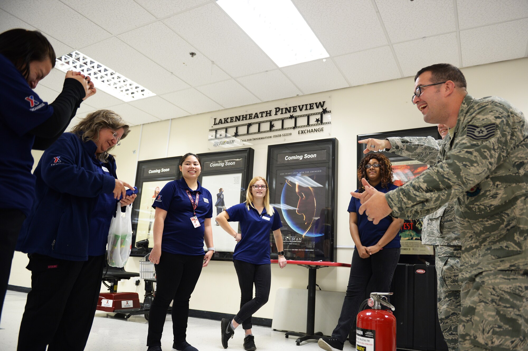 A 48th Civil Engineer Squadron  firefighter shares fire prevention tips with employees of the base exhange at Royal Air Force Lakenheath, England, Oct. 9, 2018. Fire Prevention Week is an annual campaign that educates communities on fire saftey measures. (U.S.Air Force photo/Airman 1st Class Shanice Williams-Jones)
