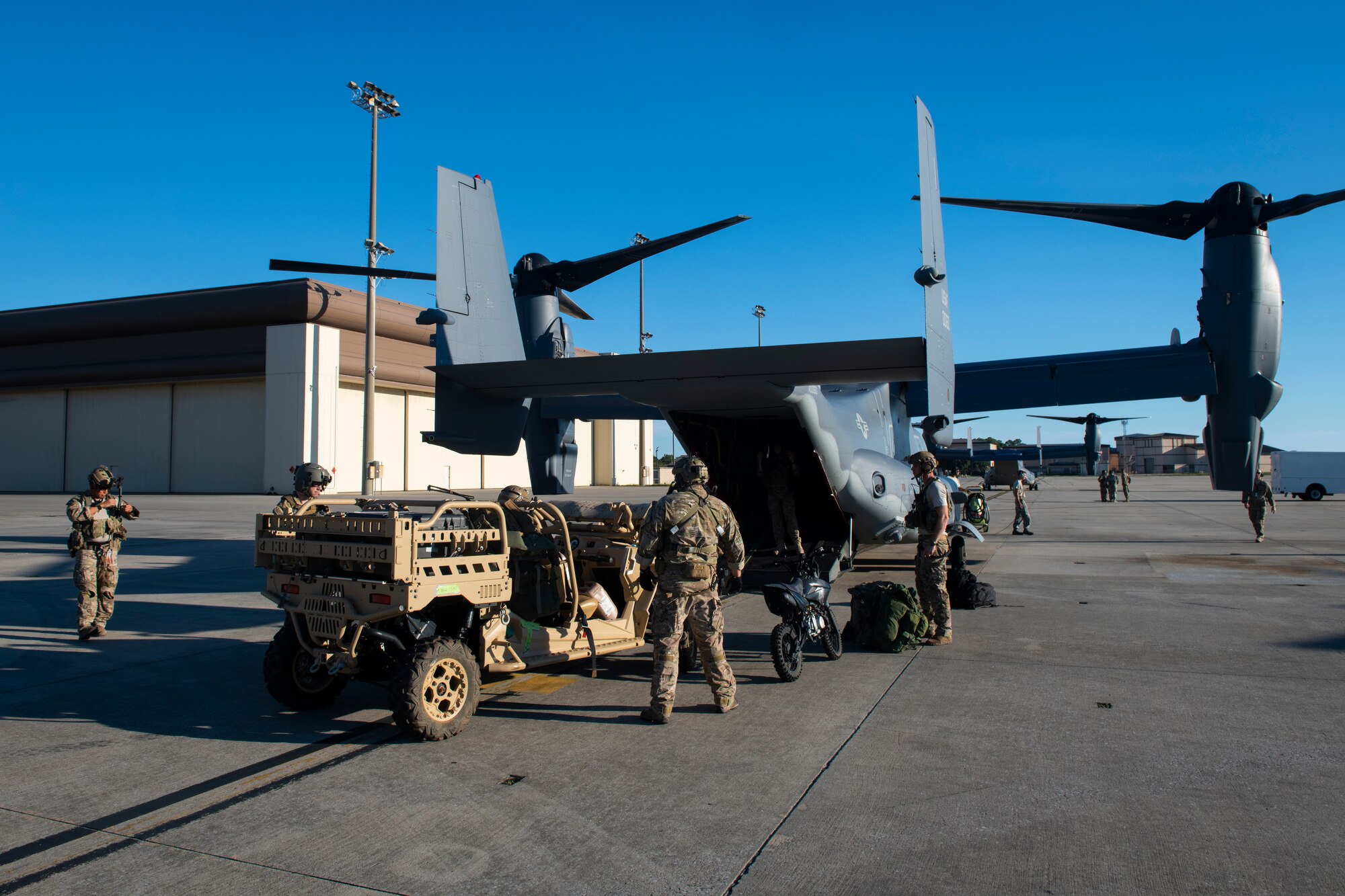 U.S. Air Force Special Tactics Airmen with the 23rd Special Tactics Squadron load cargo onto a CV-22 Osprey tiltrotor aircraft assigned to the 8th Special Operations Squadron at Hurlburt Field, Florida, Oct. 11, 2018.