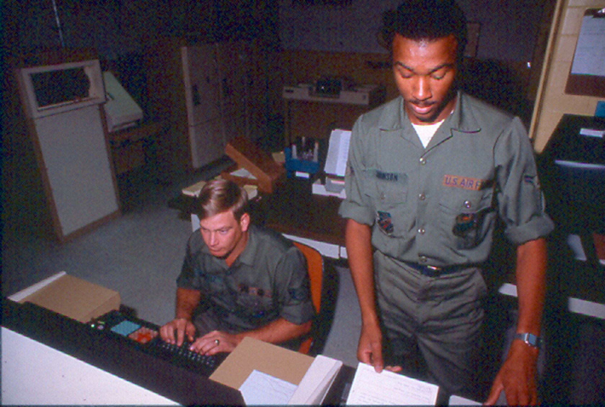 Two computer operators preparing messages for transmission in an AUTODIN terminal. (Courtesy of the AFNIC History Office)