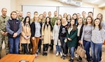 Multinational service members and local university students pose for a picture during the students visit to Yavoriv CTC Sim Centre, Oct. 10.