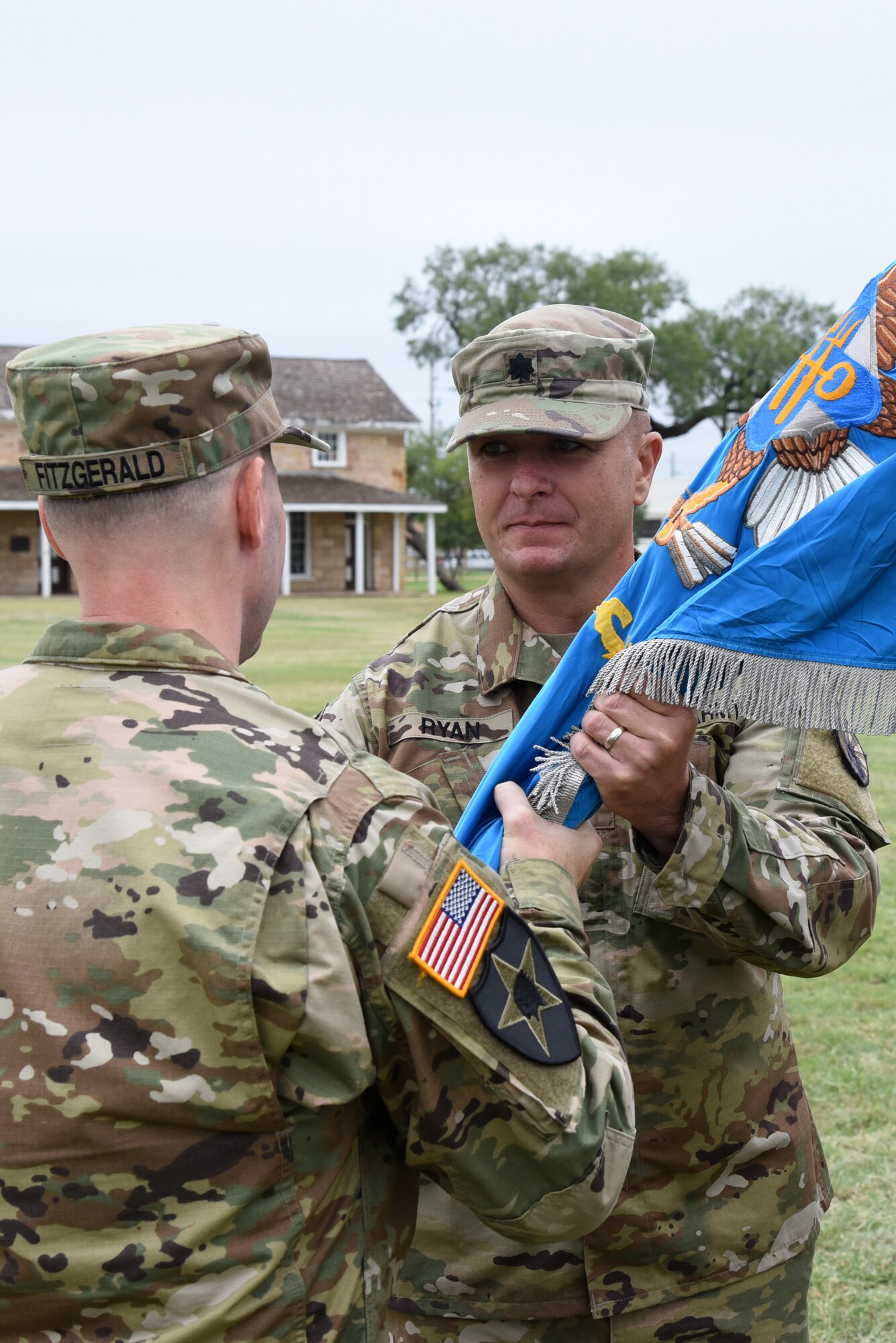 U.S. Army Col. Scott Fitzgerald, 111th Military Intelligence Brigade commander, passes the guideon to Lt. Col. Brian Ryan, 344th Military Intelligence Battalion incoming commander, during the 344th MI BN Change of Command at the Fort Concho parade field in San Angelo, Texas, Oct. 12, 2018. As the 344th MI BN commander, Ryan is responsible for developing and educating Soldiers to conduct and lead signals intelligence operations. (U.S. Air Force photo by Staff Sgt. Joshua Edwards/Released)
