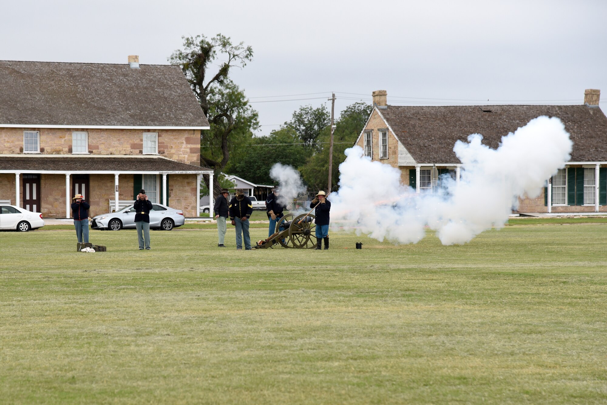 Fort Concho historic reenactors fire a cannon during the 344th Military Intelligence Battalion Change of Command at the Fort Concho parade field in San Angelo, Texas, Oct. 12, 2018. The reenactors fired the cannon to signify the start of the pass and review. (U.S. Air Force photo by Staff Sgt. Joshua Edwards/Released)