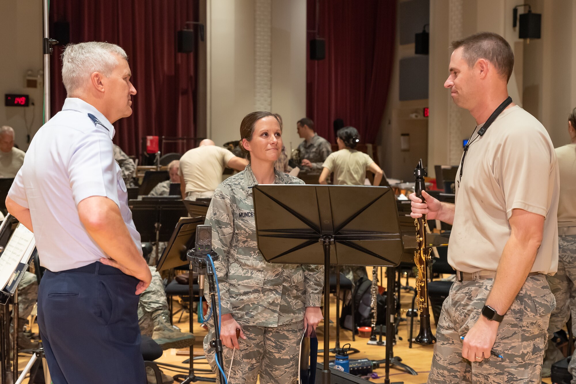 Tour soloist Senior Master Sgt. Blake Arrington confers with Col. Lang and 1st Lt. Christina Muncey