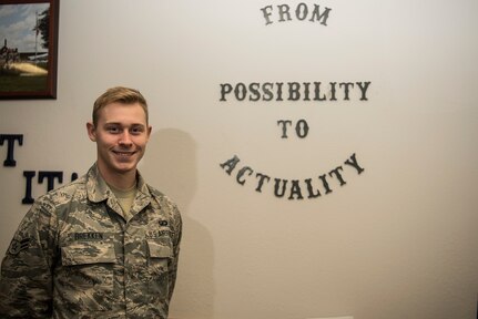 Airman 1st Class Jonathan Brekken, 628th Contracting Squadron contract specialist, stands beside his squadron’s motto Oct. 9, 2018, at Joint Base Charleston.