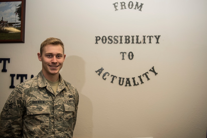 Airman 1st Class Jonathan Brekken, 628th Contracting Squadron contract specialist, stands beside his squadron’s motto Oct. 9, 2018, at Joint Base Charleston.
