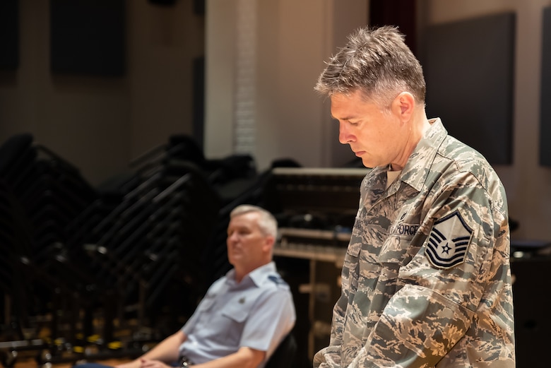 Staff Arranger Master Sgt. John Bliss overlooks a score to one of his arrangements during a rehearsal for the Fall 2019 tour
