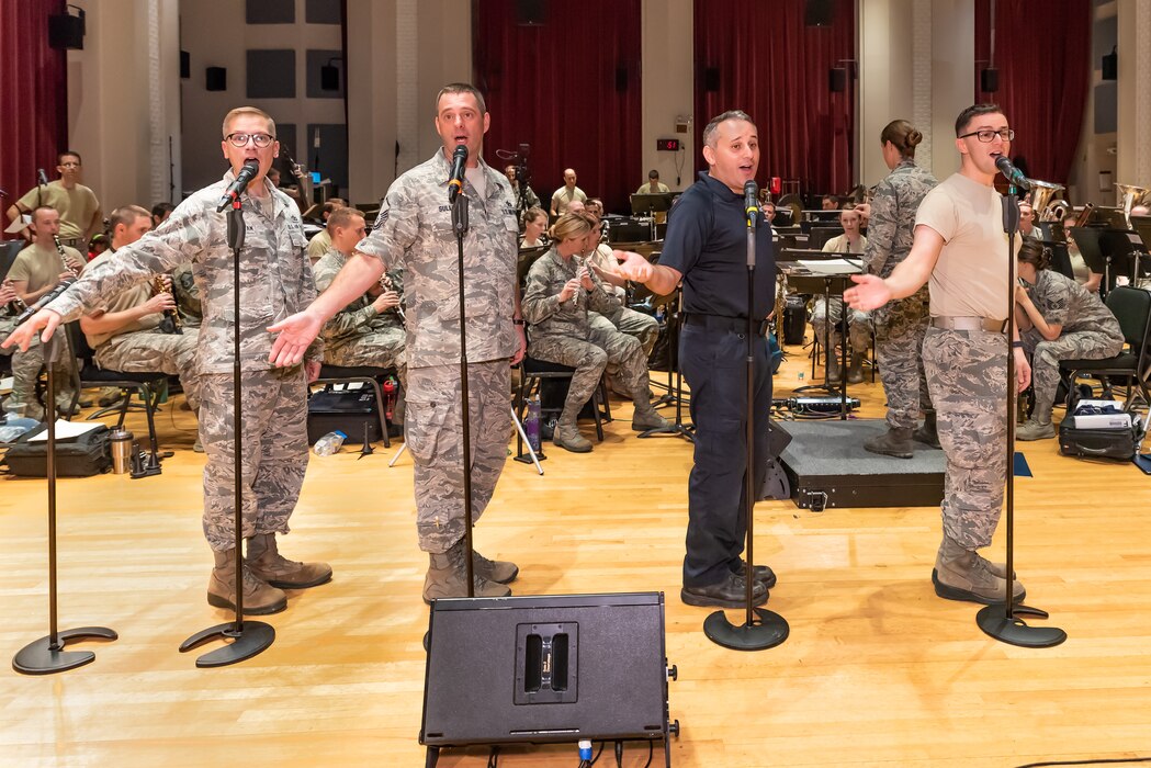 Male vocalists from the Singing Sergeants rehearse with the Concert Band in preparation for the 2018 Fall tour