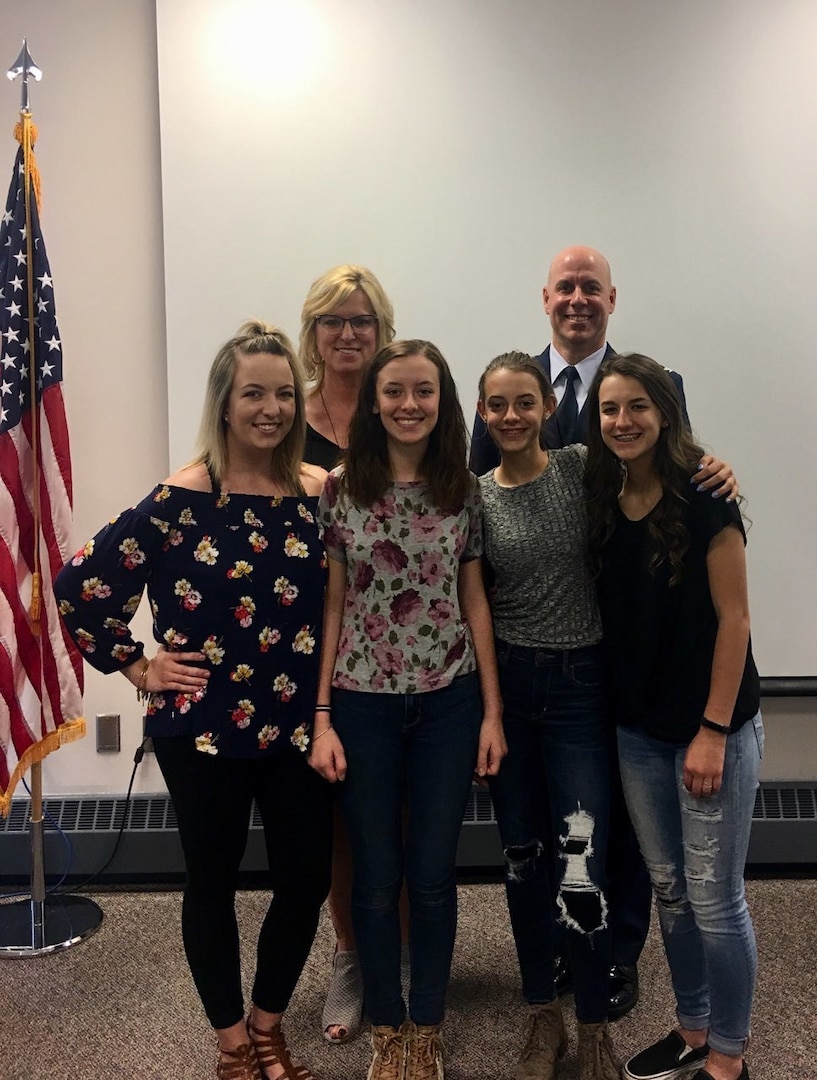 Col. Gary McCue (back right) and wife Molly stand behind their daughters Emily (from left), Josie, Zoe and Carly after Josie took the oath of enlistment May 9, 2018, to become a member of the Ohio Air National Guard.