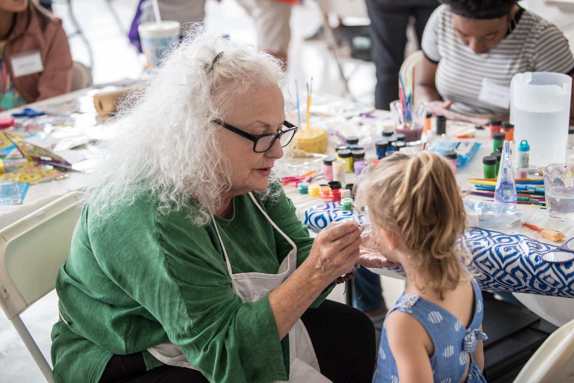 A volunteer paints a child’s face during the 123rd Airlift Wing’s Family Day at the Kentucky Air National Guard base in Louisville, Ky., on Sept. 16, 2018. The event, which was sponsored by the Airman and Family Readiness Office and the Key Volunteer Group, featured a car show, a static-display C-130 Hercules aircraft and several other activities. (U.S. Air National Guard photo by Master Sgt. Phil Speck)