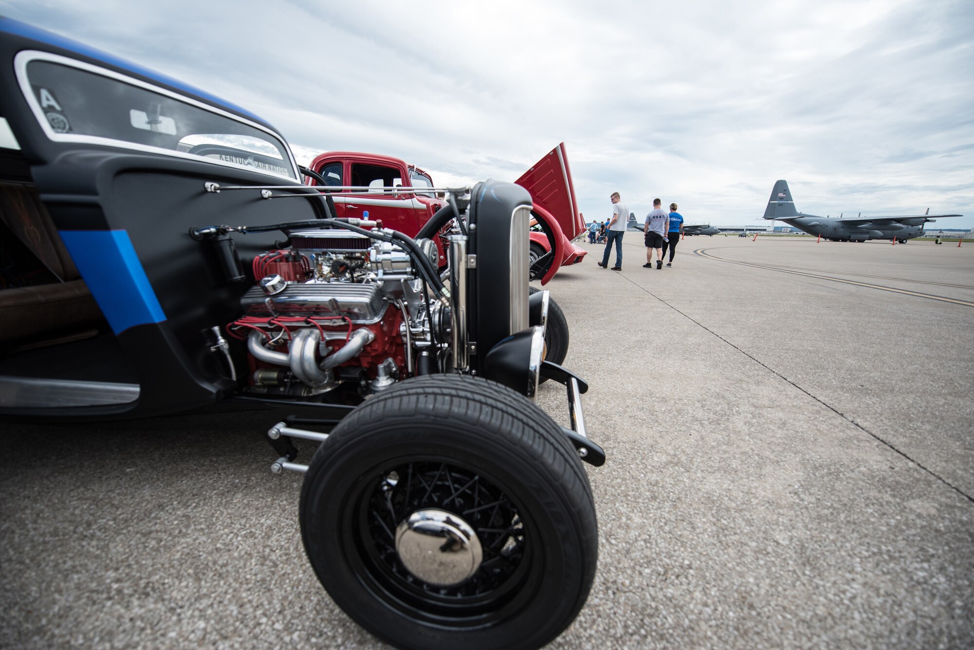 Vintage cars sit on the 123rd Airlift Wing flight line during Family Day at the Kentucky Air National Guard Base in Louisville, Ky., on Sept. 16, 2018. The event, which was sponsored by the Airman and Family Readiness Office and the Key Volunteer Group, also featured a static-display C-130 Hercules aircraft and several other activities. (U.S. Air National Guard photo by Master Sgt. Phil Speck)