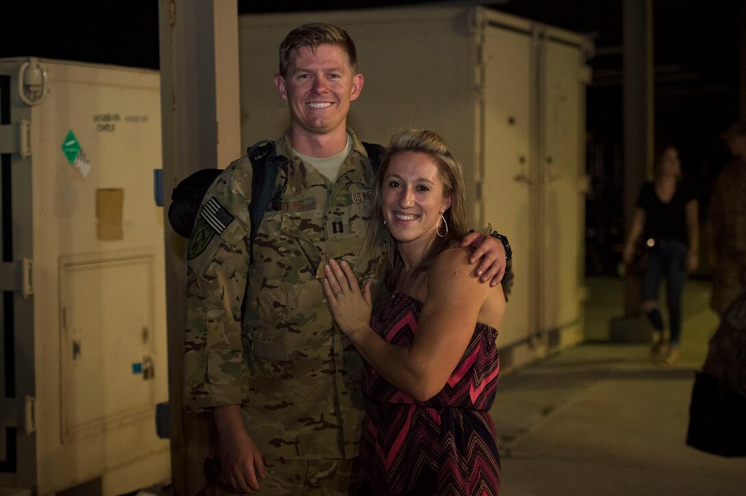 Capt. Kenneth Wilkins, 41st Rescue Squadron (RQS) HH-60G Pave Hawk helicopter pilot, reunites with his wife, Capt. Abbey Wilkins, after returning home from a deployment, Oct. 9, at Moody Air Force Base, Ga. While deployed, the 41st RQS and the 41st Helicopter Maintenance Unit provided combat search and rescue capabilities and maintenance operations in a forward location. (U.S. Air Force photo by Senior Airman Greg Nash)
