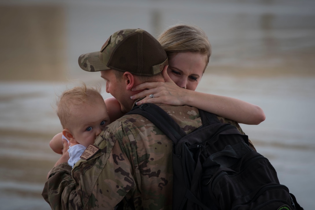 Staff Sgt. David Garman, 723d Aircraft Maintenance Squadron (AMXS) integrated electronic warfare systems journeyman, embraces loved ones during a redeployment ceremony, Oct. 9, 2018, at Moody Air Force Base, Ga. The 71st Rescue Squadron maintains combat-ready status and provides deployable personnel recovery forces to theater commanders for contingency and crisis response operations worldwide. (U.S. Air Force photo by Airman Taryn Butler)