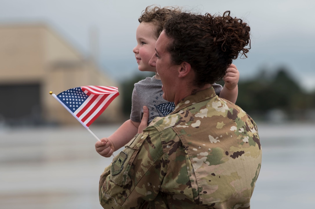 Tech. Sgt. Colleen McGahuey-Ramsey, 71st Rescue Squadron (RQS) flight chief, reunites with her son during a redeployment ceremony, Oct. 9, 2018, at Moody Air Force Base, Ga. The 71st Rescue Squadron maintains combat-ready status and provides deployable personnel recovery forces to theater commanders for contingency and crisis response operations worldwide. (U.S. Air Force photo by Airman Taryn Butler)