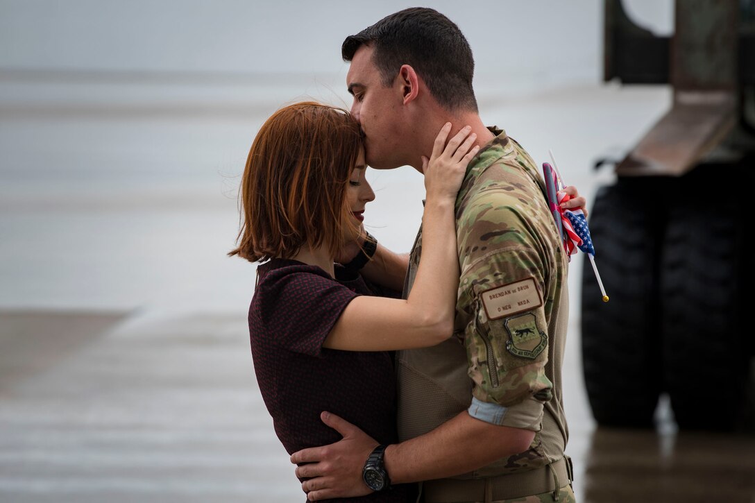 Capt. Brendan Debrun, 71st Rescue Squadron (RQS) resource advisor, kisses a loved one during a redeployment ceremony, Oct. 9, 2018, at Moody Air Force Base, Ga. The 71st Rescue Squadron maintains combat-ready status and provides deployable personnel recovery forces to theater commanders for contingency and crisis response operations worldwide. (U.S. Air Force photo by Airman Taryn Butler)