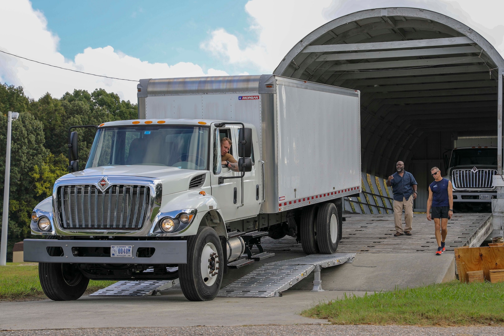 Chief Petty Officer Benjamin Allen (driver) loads a box truck onto a mockup Boeing C-17 Globemaster III while T.C. Lasker (left) and Tim Collins (right) guide him in during an air load test Oct. 9, 2018 at the C-17 Training Area at Fort Eustis, Va. This test was part of an air load plan reconfiguration and verified that two box trucks can fit side-by-side on a C-17. When directed, JTF-CS is ready to respond in 24 hours to provide command and control of 5,200 federal military forces located at more than 36 locations throughout the nation in support of civil authority response operations to save lives, prevent further injury and provide critical support to enable community recovery. (Official DoD photo by Mass Communication Specialist 3rd Class Michael Redd/released)