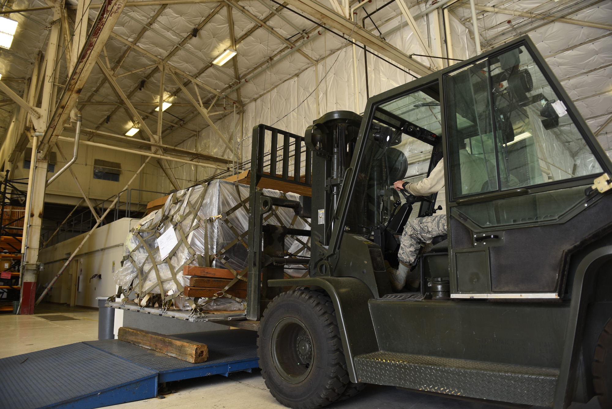Staff Sgt. Rey Solis, 92nd Logistics Readiness Squadron vehicle maintenance, operates a forklift carrying cargo to be loaded onto a KC-135 Stratotanker at Fairchild Air Force Base, Washington, Sept. 21, 2018. LRS Airmen have a variety of mission sets including vehicle maitnenance, individual protection equipment, air transportation operations and more, which are essential to mission success. (U.S. Air Force phot/Airman 1st Class Lawrence Sena)