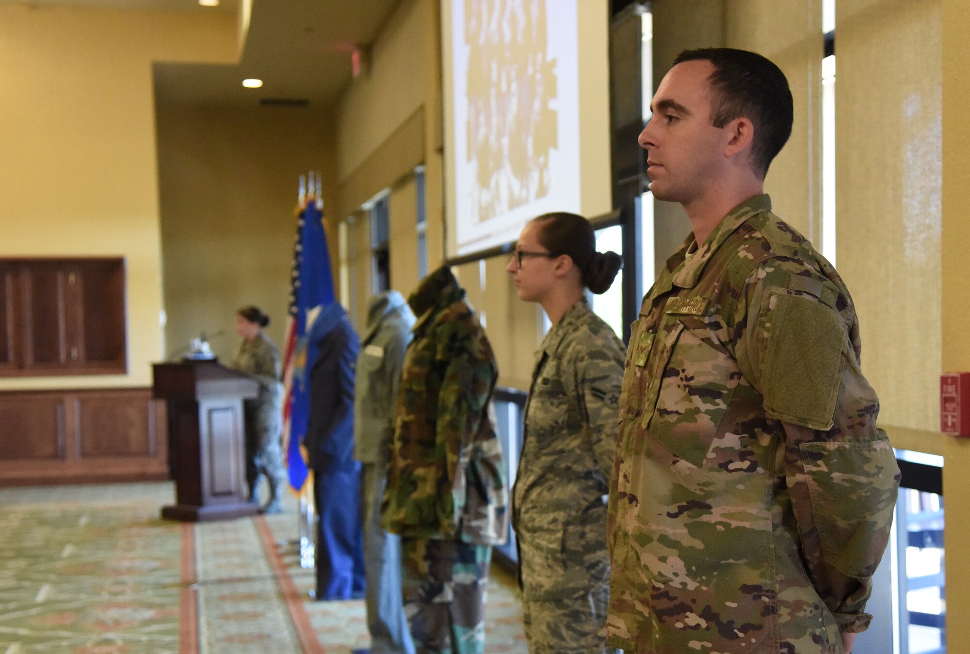 U.S. Air Force Senior Airman Travis Beihl and Airman 1st Class Suzanna Plotnikov, 81st Training Wing photojournalists, participate in a historical presentation during the Biloxi Chamber Morning Call in the Bay Breeze Event Center at Keesler Air Force Base, Mississippi, Oct. 11, 2018. Local business and community leaders attended the event, hosted by the 81st TRW, to learn more about the base’s mission and its Airmen. (U.S. Air Force photo by Kemberly Groue)