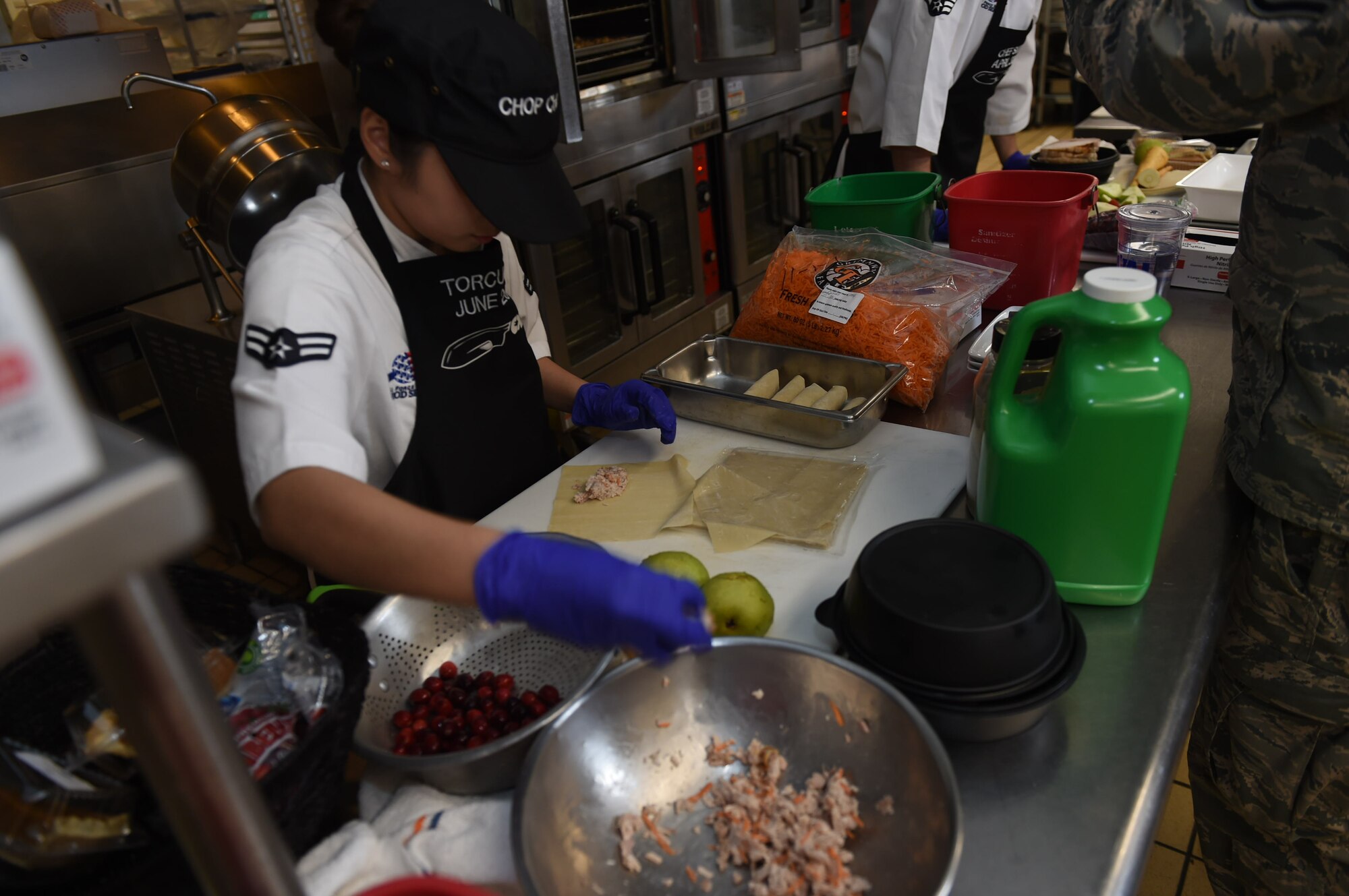 U.S. Air Force Airman 1st Class Michelle Vi Torculas, a food services specialist assigned to the 97th Force Support Squadron, prepares her dish that she will give to the judges for the 2017 Chopped Chef Challenge, November 28, 2017, at Altus Air Force Base, Okla. The competitors were given a basket containing six random ingredients to create a three-course meal within two hours. Torculas won the region two 2018 Arthur J. Myers Food Service Excellence Award for her hard work in events like this and in her career. (U.S. Air Force photo by Senior Airman Kirby Turbak)