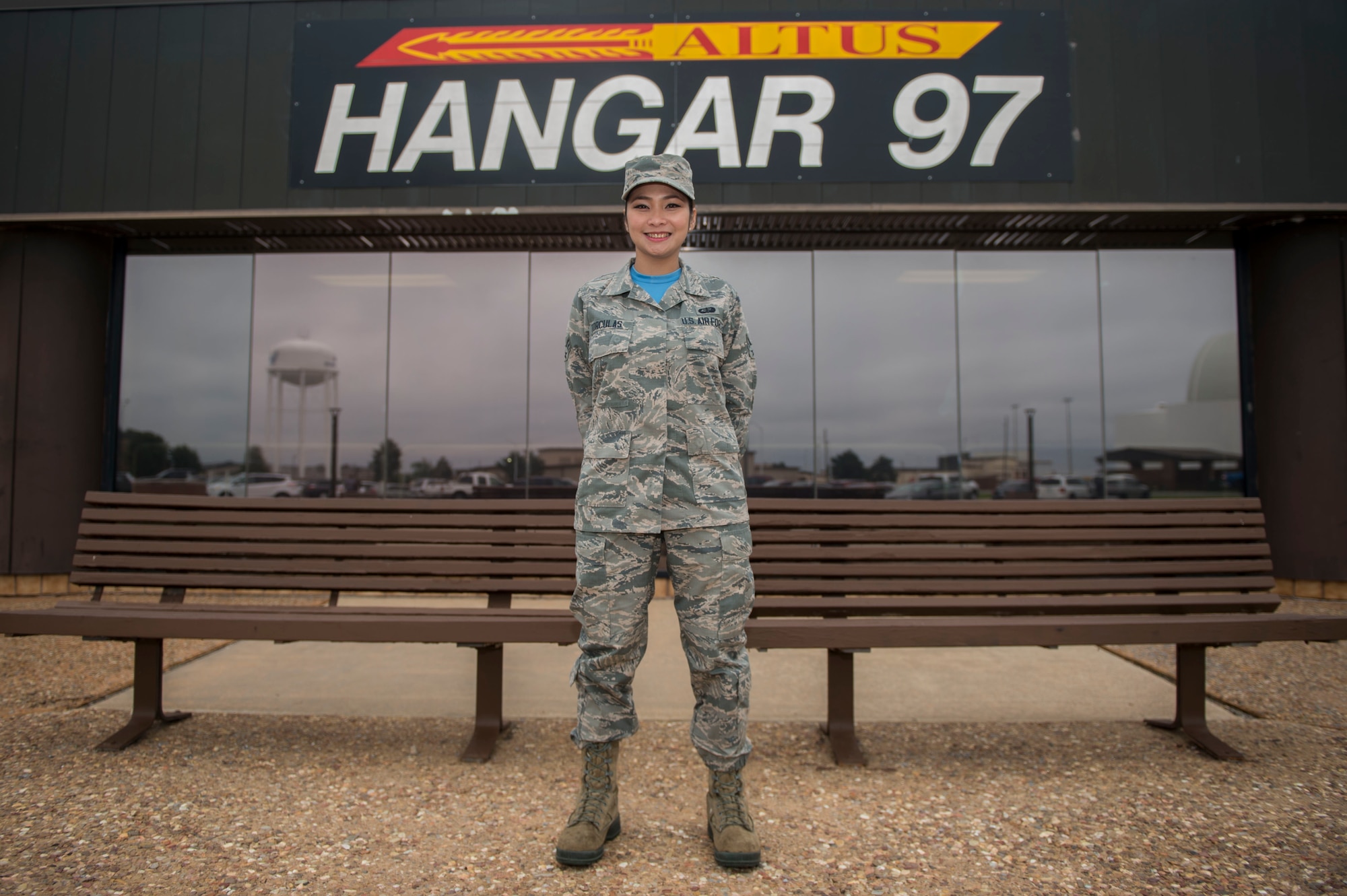 U.S. Air Force Airman 1st Class Michelle Vi Torculas, a food services specialist assigned to the 97th Force Support Squadron, stands outside the Hangar 97 Dining Facility where she works, Oct. 12, 2018, at Altus Air Force Base, Okla. Torculas won the region two 2018 Arthur J. Myers Food Service Excellence Award for her hard work in her career field. (U.S. Air Force photo by Senior Airman Cody Dowell)