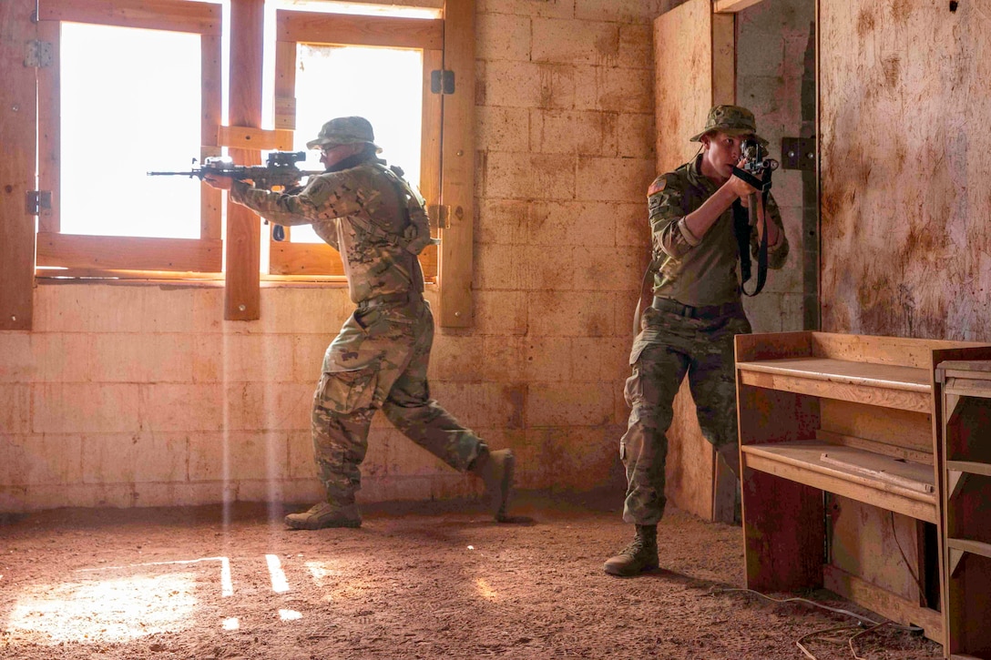Army Special Forces paratroopers enter a building during close quarters battle training