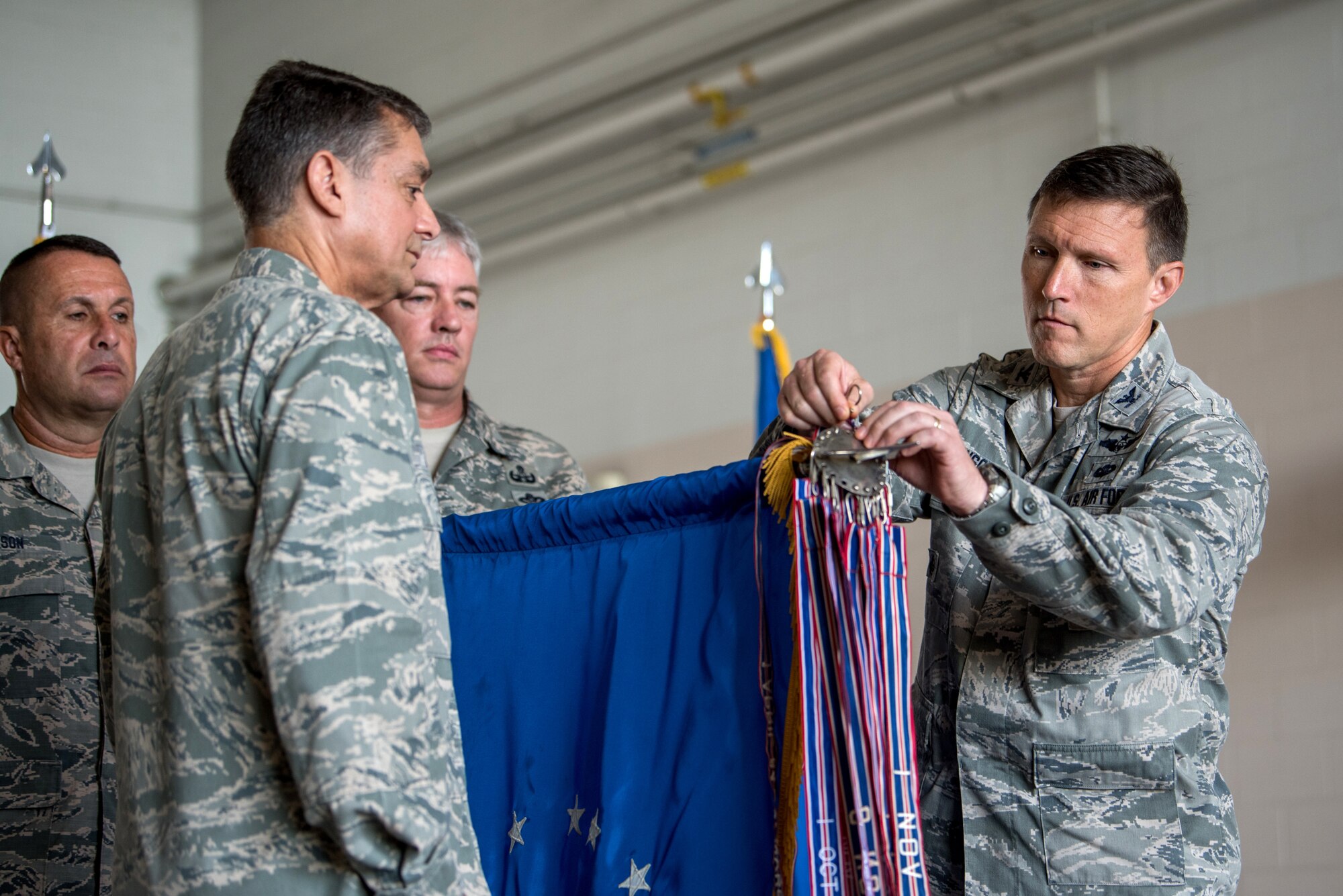 Col. Jeffrey Wilkinson (right), commander of the 123rd Airlift Wing, pins a streamer representing the unit’s 17th Air Force Outstanding Unit Award to the wing guidon during a ceremony at the Kentucky Air National Guard Base in Louisville, Ky., Sept. 16, 2018. The award is one of many which contributes to the wing’s status as one of the most decorated units in Air Force history. (U.S. Air National Guard photo by Staff Sgt. Joshua Horton)