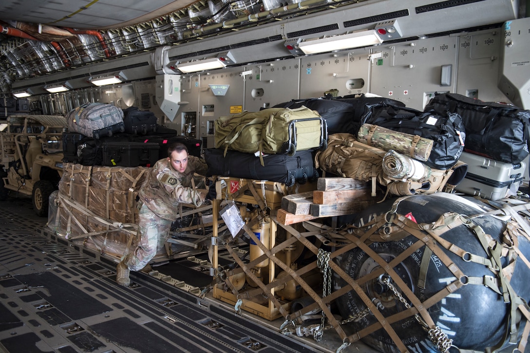 Senior Airman Clinton Andrews, 821st Contingency Response Support Squadron aerial porter, offloads cargo from a Travis Air Force Base C-17 Globemaster III at Tyndall Air Force Base, Florida, Oct. 12, 2018. The contingency response team deployed to assess damage and establish conditions for the re-initiation of airflow, bringing much needed equipment, supplies and personnel for the rebuilding of the base in the aftermath of Hurricane Michael. AMC equipment and personnel stand by across the nation to provide even more support upon request (U.S. Air Force photo by Tech. Sgt. Liliana Moreno)