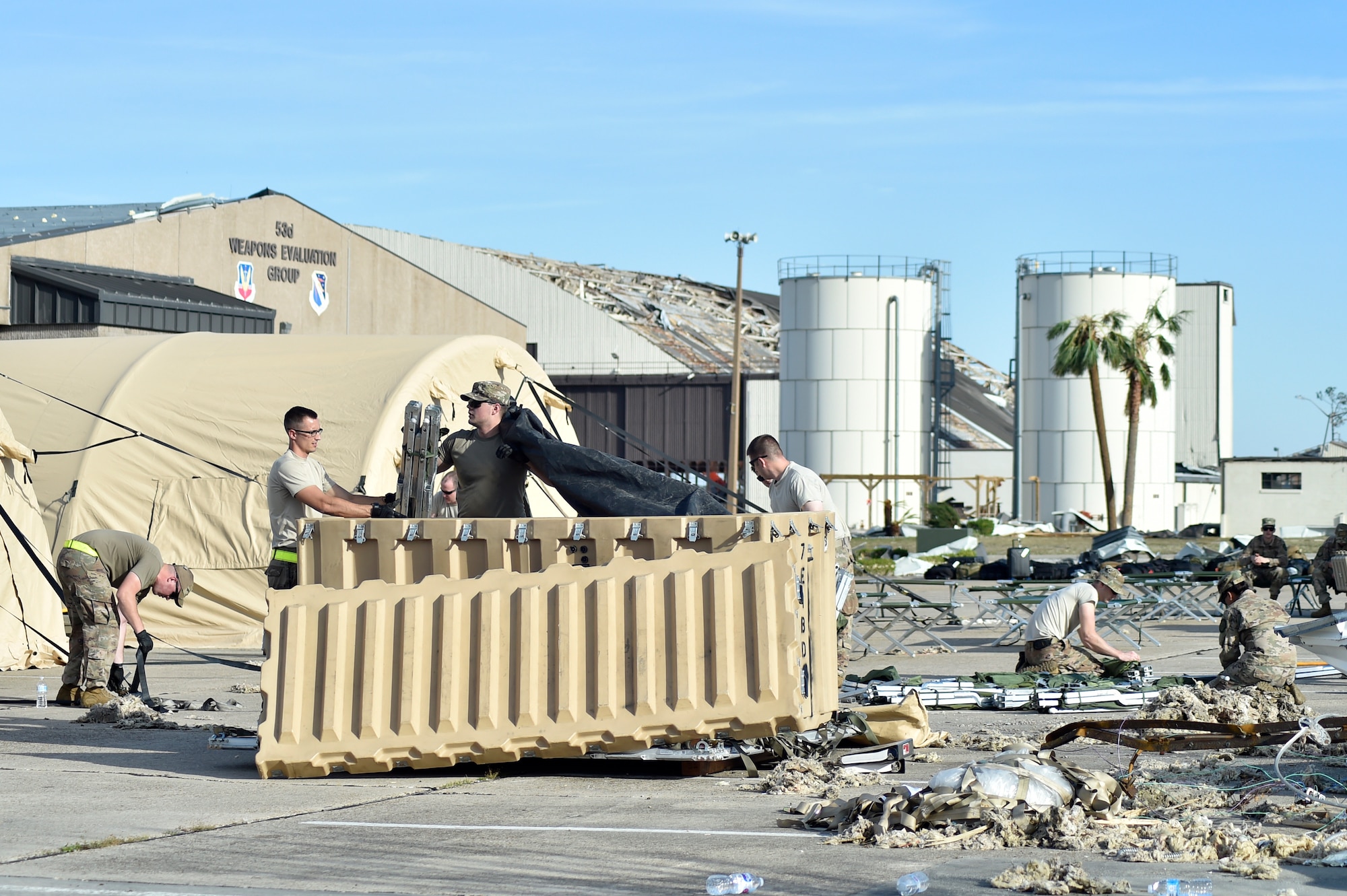 Airmen from the 821st Contingency Response Group setup tent city at Tyndall Air Force Base, Florida, Oct. 12, 2018. The contingency response team deployed to assess damage and establish conditions for the re-initiation of airflow, bringing much needed equipment, supplies and personnel for the rebuilding of the base in the aftermath of Hurricane Michael. AMC equipment and personnel stand by across the nation to provide even more support upon request (U.S. Air Force photo by Tech. Sgt. Liliana Moreno)