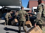 Florida National Guard Soldiers from the 53rd Infantry Brigade Combat Team, 2-124 Charlie Co., Ocala, Fla., load food in to a local citizen’s vehicle during Hurricane Michael disaster relief, Panama City, Fla., Oct. 13, 2018.  Soldiers respond in communities throughout the panhandle in conjunction with civilian emergency services.