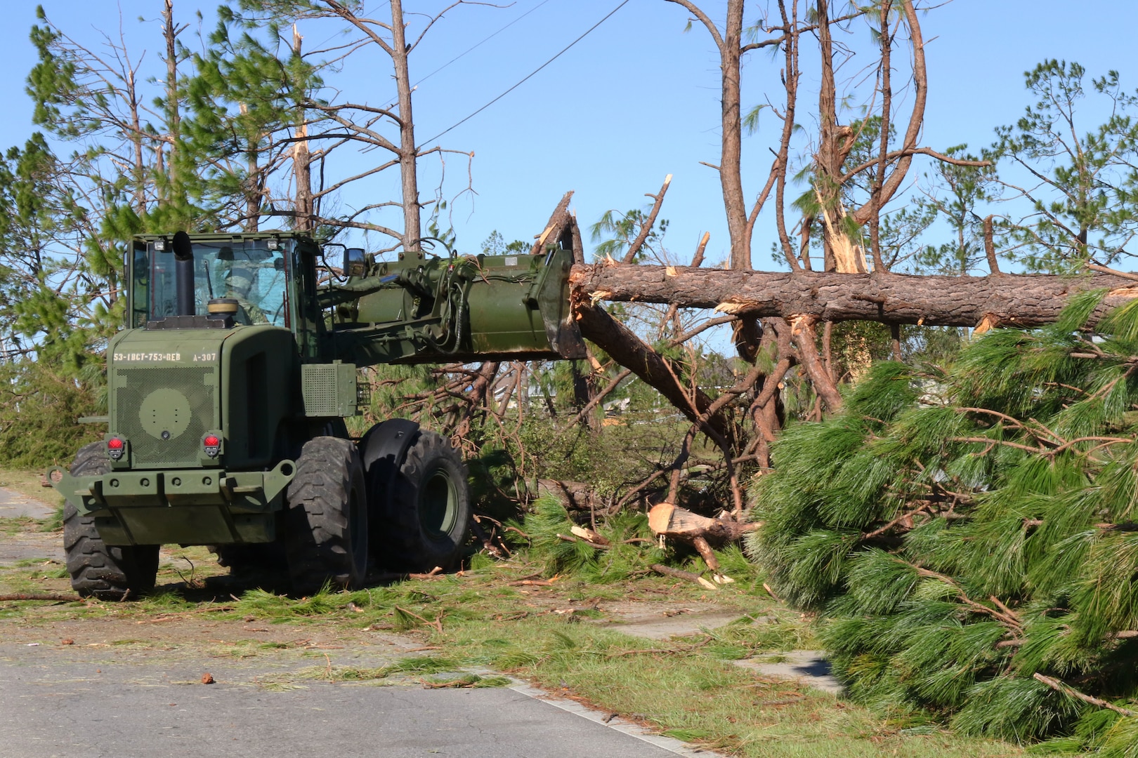 Florida National Guard members of the 753rd Brigade Engineer Battalion, Alpha Co. from Tallahassee, Florida, clear roadways as part of the widespread debris cleanup Oct. 13, 2018, in Panama City, Florida.