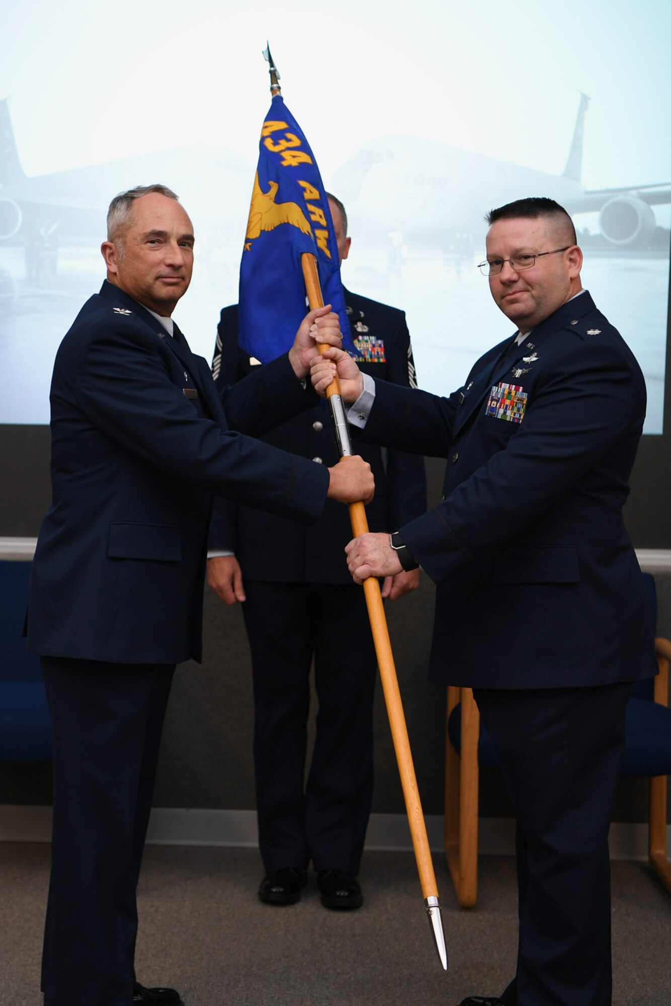 Lt. Col. David O’Neil, 434th Communication Squadron commander, receives the 434th ARW guidon from Col. Scott Russell, 434th Mission Support Group commander, during an assumption of command ceremony at Grissom Air Reserve Base, Ind., October 13, 2018. O’Neil has worked in joint information operations and specializes in influence operations and cyber warfare.
 (U.S. Air Force photo/Staff. Sgt. Courtney Dotson-Essett)