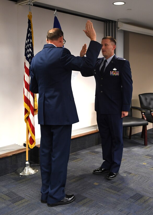 Lt. Col. Brett J. Dorey, commander of the 911th Force Support Squadron, recites the Reaffirmation of Oath facilitated by 911th Mission Support Commander Col. Kenneth M. Lute during a ceremony at the Pittsburgh International Airport Air Reserve Station, Pennsylvania, Oct. 13, 2018. Officers take the oath upon commissioning and reaffirm the oath at each promotion to endure they understand the significance of their position. (U.S. Air Force photo by Senior Airman Grace Thomson)