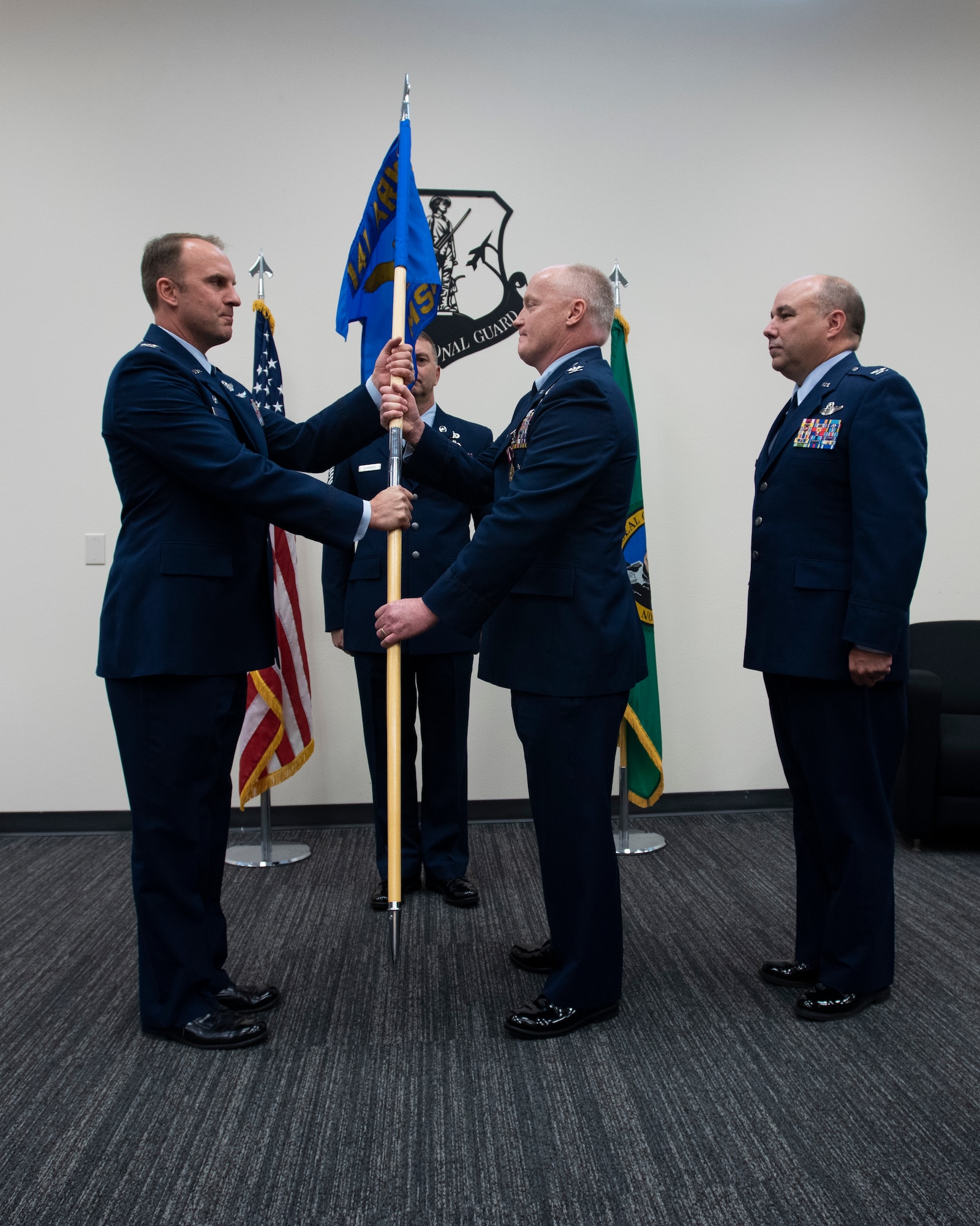 Col. Johan Deutscher, 141st Air Refueling Wing commander, accepts the 141st Mission Support Group guidon from Col. Mark Sweitzer, 141st MSG commander, during a change of command ceremony October 13, 2018 at Fairchild Air Force Base, Wash. During the ceremony, a guidon is passed to symbolize the passing of responsibility from one commander to another. (U.S. Air National Guard photo by Tech. Sgt. Michael Lee Brown)