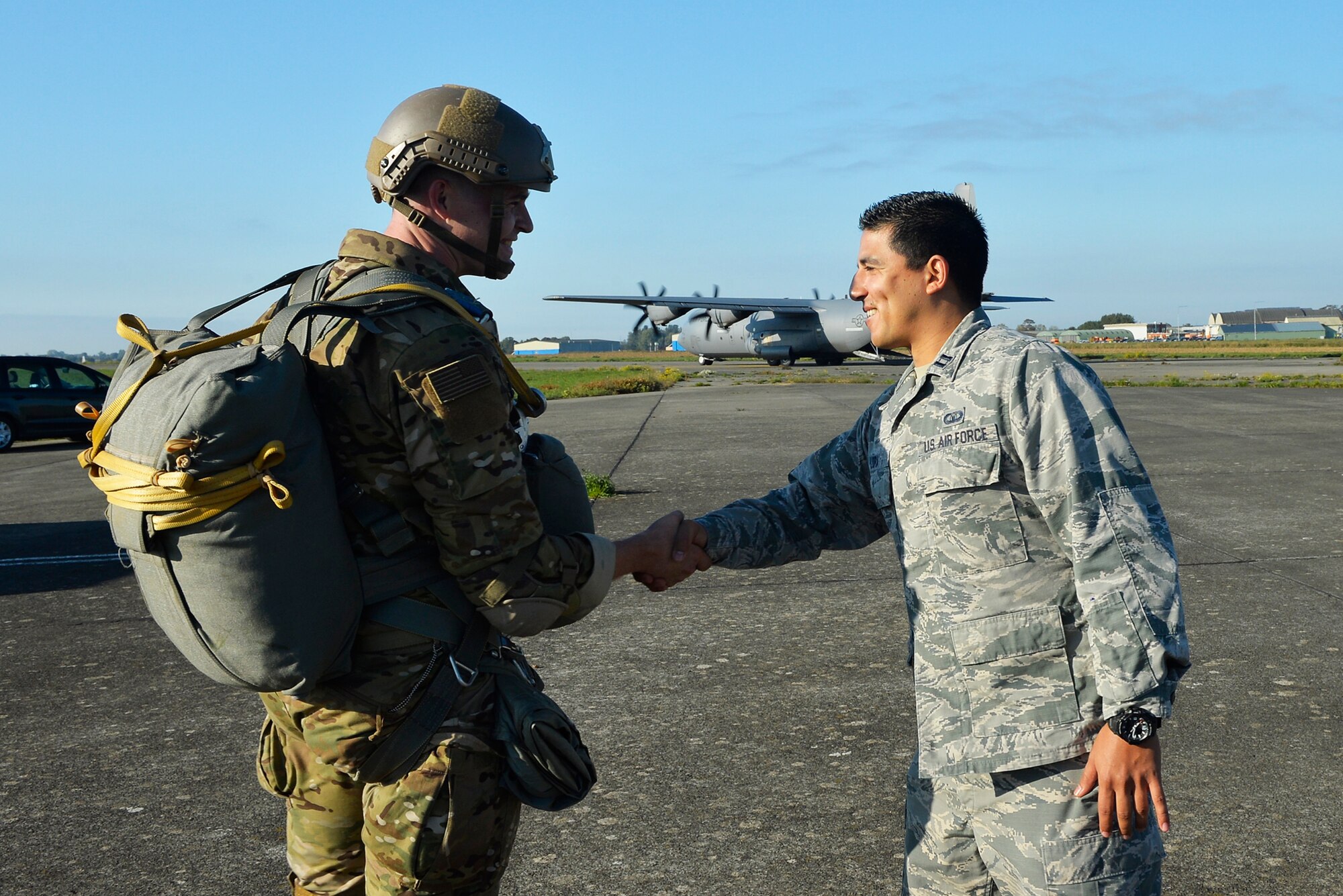 U.S. Air Force Capt. Christian Lora, 424th Air Base Squadron airfield operations flight commander, right, shakes hands with a 435th Air Ground Operations Wing paratrooper on Chievres Air Base, Belgium, Oct. 4, 2018. As a geographically separated unit of the 86th Airlift Wing at Ramstein Air Base, Germany, the 424th ABS conducts airfield support operations for U.S. and NATO forces. (U.S. Air Force photo by Senior Airman Joshua Magbanua)
