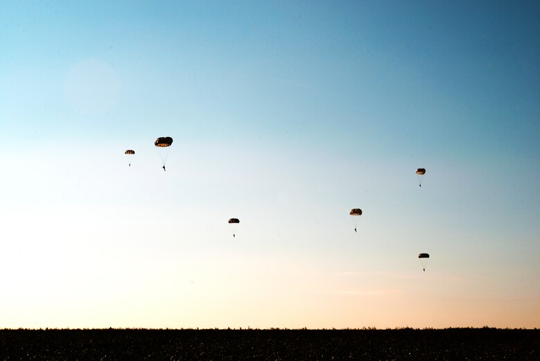 Parajumpers assigned to the 435th Air Ground Operations Wing descend upon a field at Chievres Air Base, Belgium, Oct. 4, 2018. Leaders at the 424th Air Base Squadron have been pushing to expand Supreme Headquarters Allied Powers Europe Airfield’s capacity to support airlift missions. (U.S. Air Force photo by Senior Airman Joshua Magbanua)