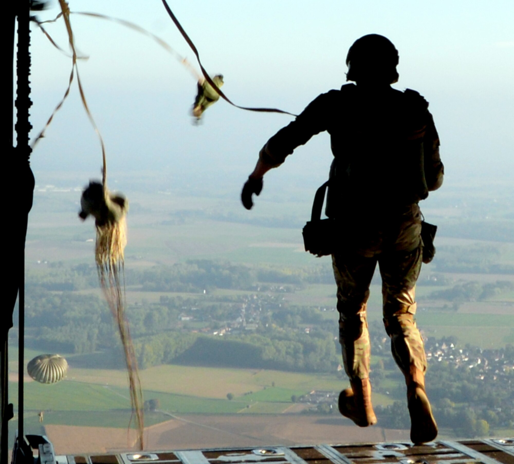 A parajumper airdrops from a C-130J Super Hercules aircraft over Chievres Air Base, Belgium, Oct. 4, 2018. Twelve parapjumpers participated in the jump on Chievres as a co-operablity exercise between Airmen from Chievers and Ramstein Air Base to show the base's ability to extend air power to Belgium. (U.S Air Force photo by Airman 1st Class Ariel Leighty)