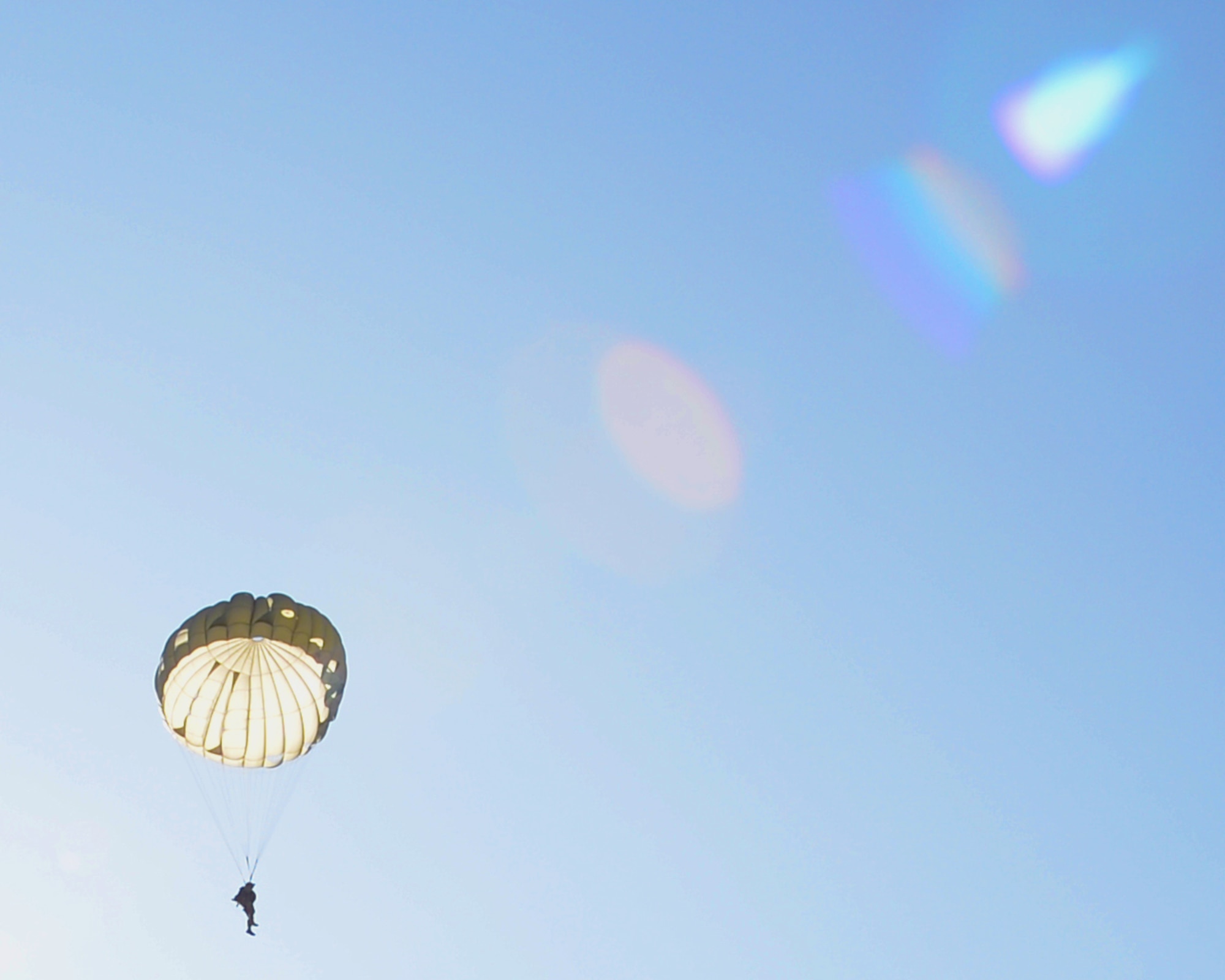 A parajumper descends from a C-130J Super Hercules aircraft over Chievres Air Base, Belgium, Oct. 4, 2018. Twelve parapjumpers participated in the jump on Chievres as a co-operablity exercise between Airmen from Chievers and Ramstein Air Base to show the base's ability to extend air power to Belgium. (U.S Air Force photo by Airman 1st Class Ariel Leighty)