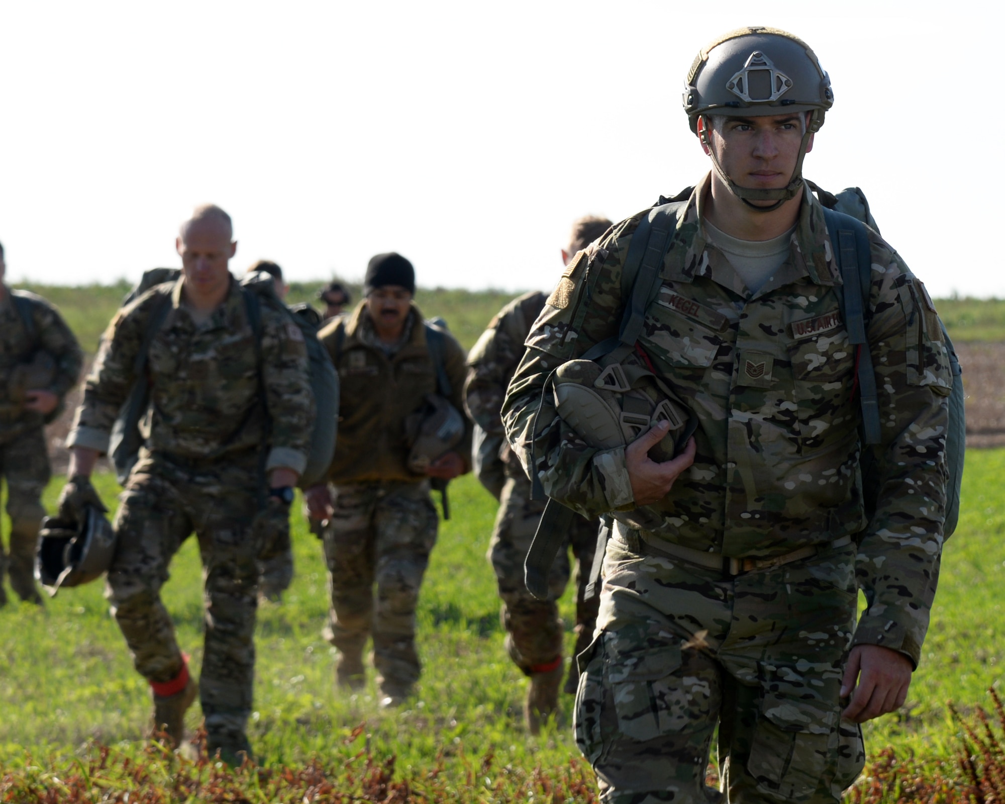 Airman assigned to the 435th Contingecy Respons Squadron return to the drop zone after parajumping from a C-130J Super Hercules aircraft, on Chievres Air Base, Belgium, Oct. 4, 2018. This is the first time in 51 years that parajumpers have conducted an interoperablity exercise on Chievres. (U.S. Air Force photo by Airman 1st Class Leighty)