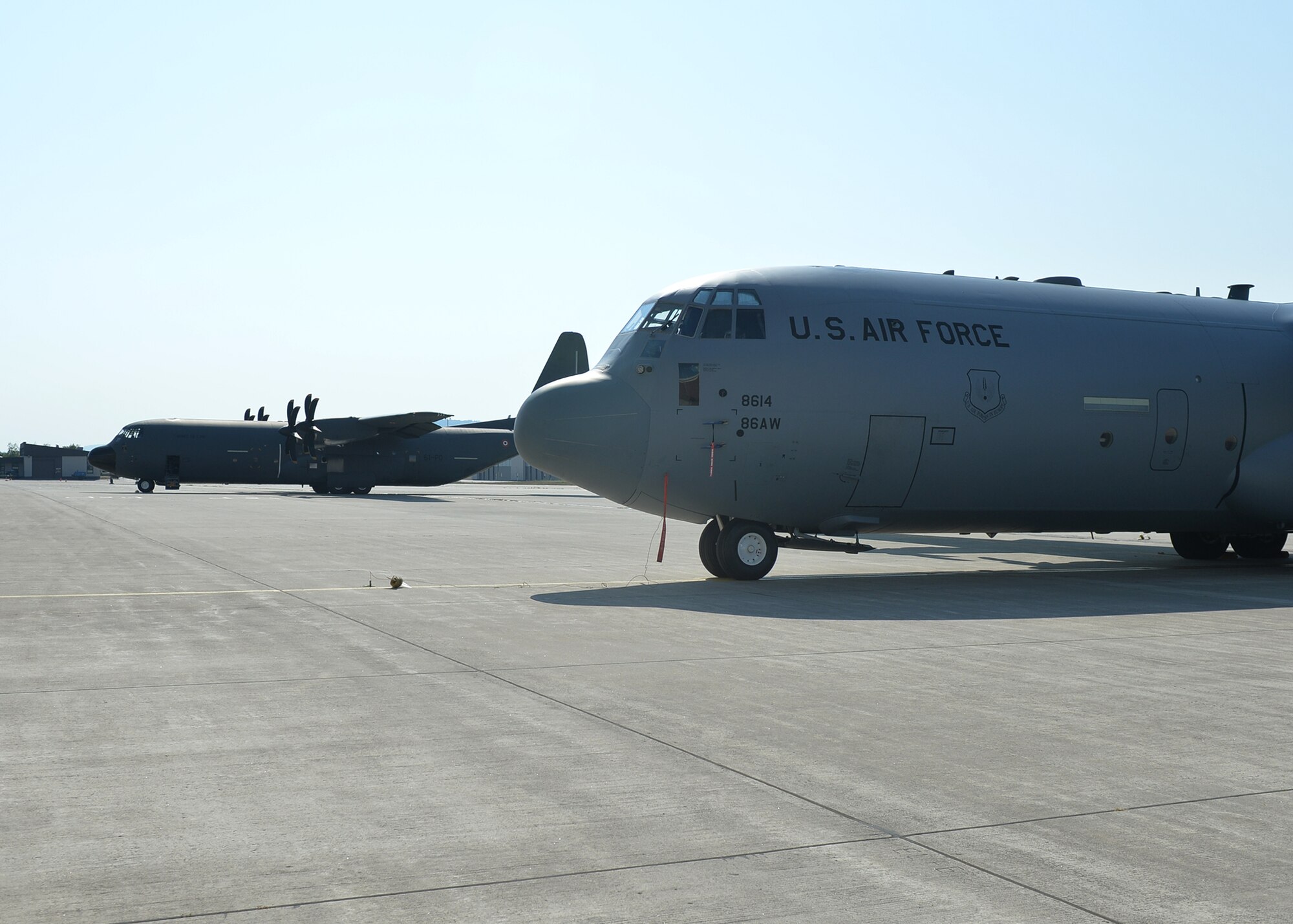 A U.S. Air Force C-130J Super Hercules aircraft sits next to a French air force C-130J on Ramstein Air Base, Germany, Aug. 3, 2018. The C-130J is 15 feet longer than the legacy ‘E’ and ‘H’ models, and also uses propellers with six blades instead of four. (U.S. Air Force photo by Staff Sgt. Jimmie D. Pike)